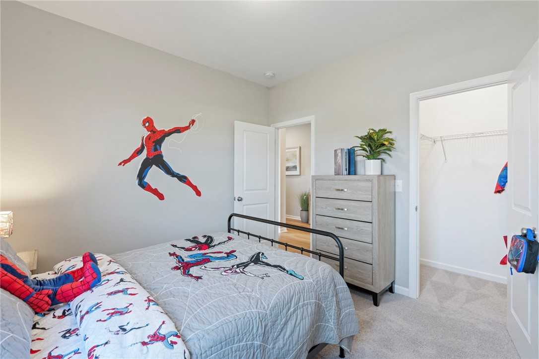 Fun Spider-Man themed child's bedroom with twin bed, modern dresser and closet in Davidson Homes The Phoenix B, Opelika, Alabama
