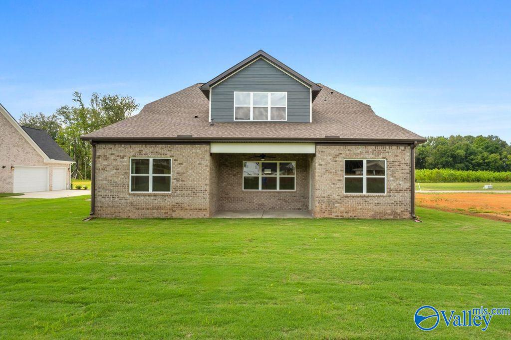 Brick 1.5-story The Oxford home with gabled roof, covered entry, and two-car garage in The Meadows at Hampton Cove, Owens Cross Roads, Alabama