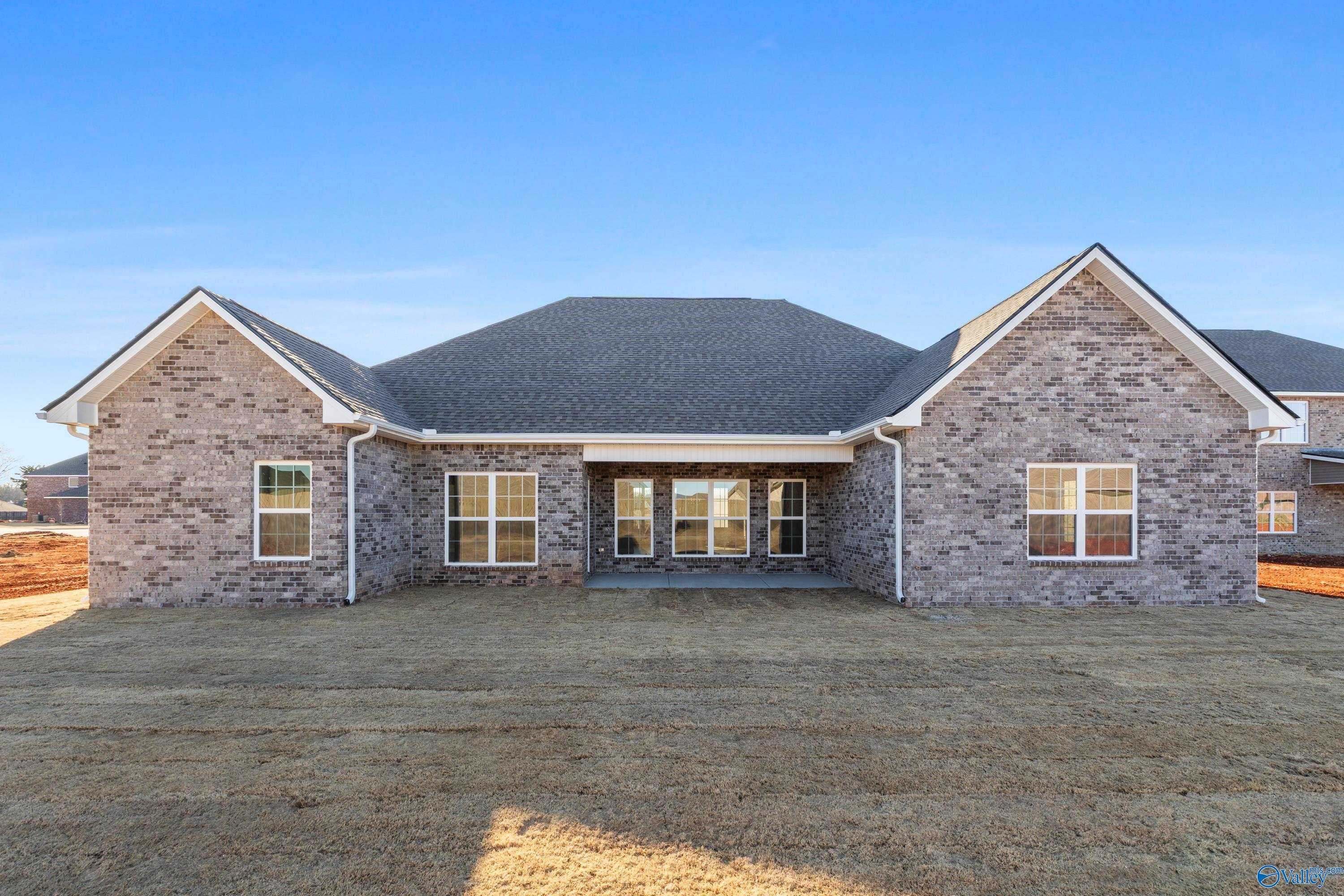 Brick 1-story Valencia home by Davidson Homes in Briercreek, Meridianville, AL, featuring large windows and covered entry