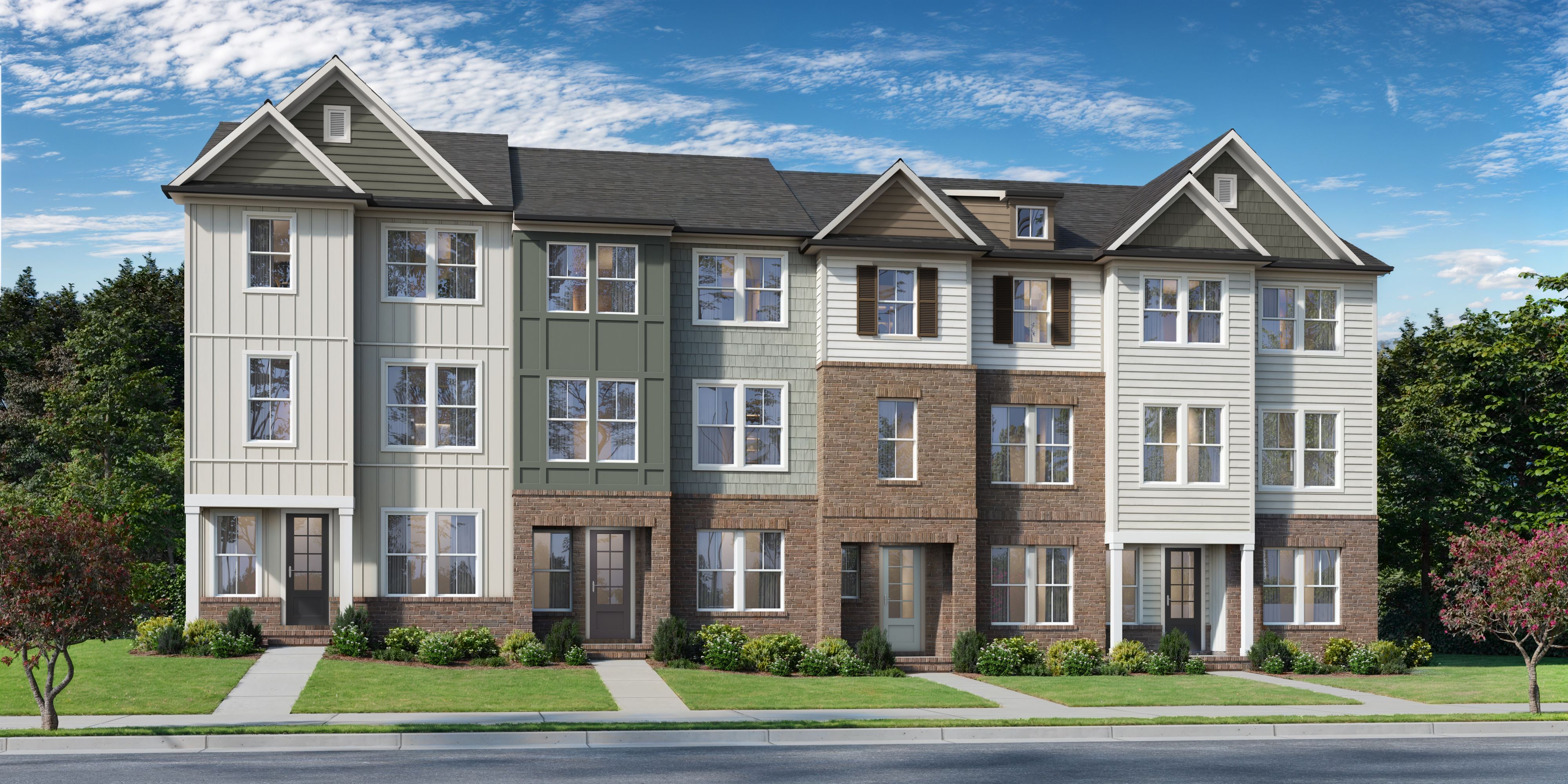 Row of modern townhomes at Camden Park in Knightdale NC with varied siding, gabled roofs, and landscaped front yards by Davidson Homes