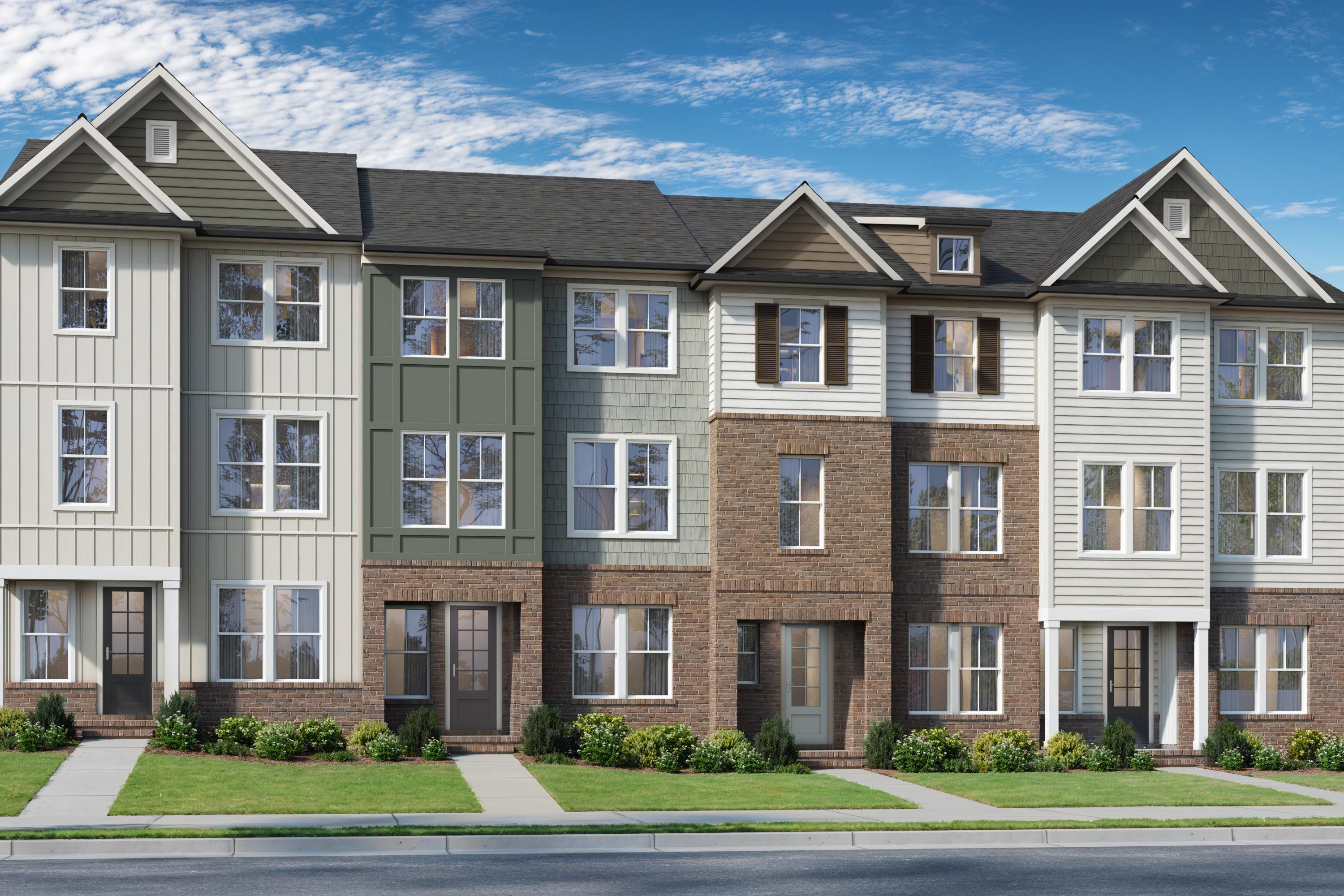 Row of modern townhomes at Camden Park in Knightdale NC with varied siding, gabled roofs, and landscaped front yards by Davidson Homes