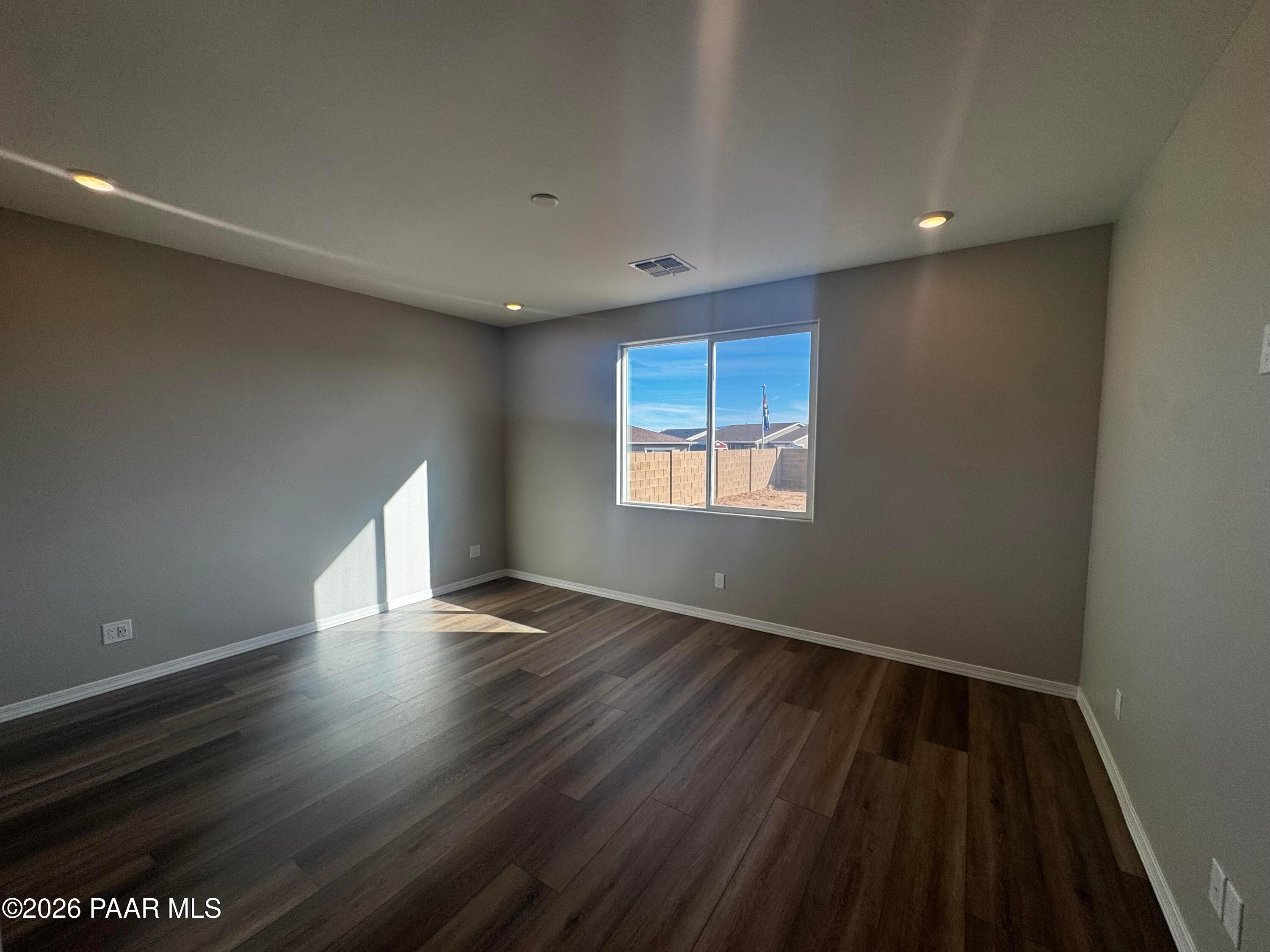 Bright empty bedroom with desert mountain view through large window in Davidson Homes Daybreak B, Prescott AZ