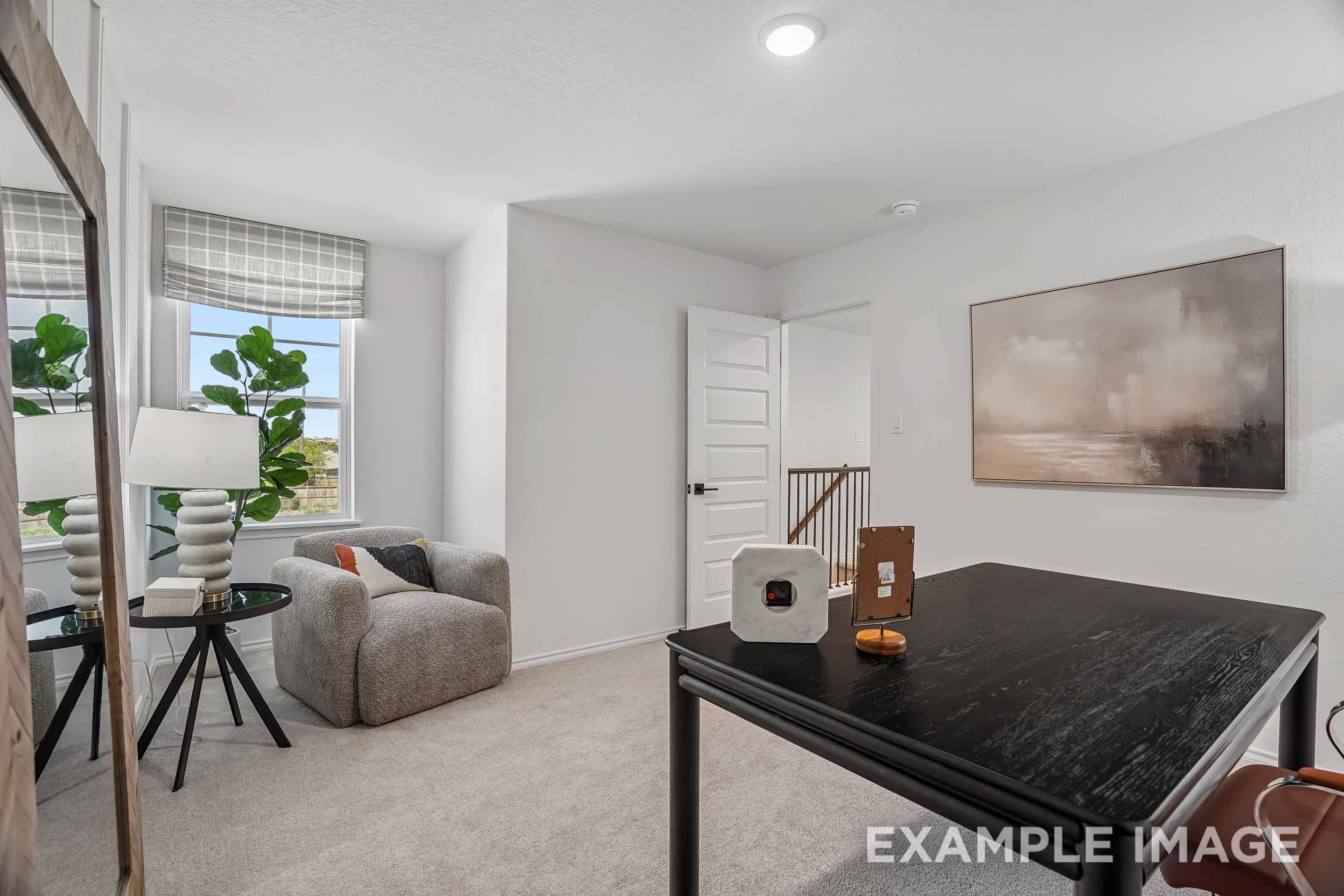 Bright home office in The Pinecrest D floor plan featuring a desk, cozy reading nook, and large window in San Antonio, TX.