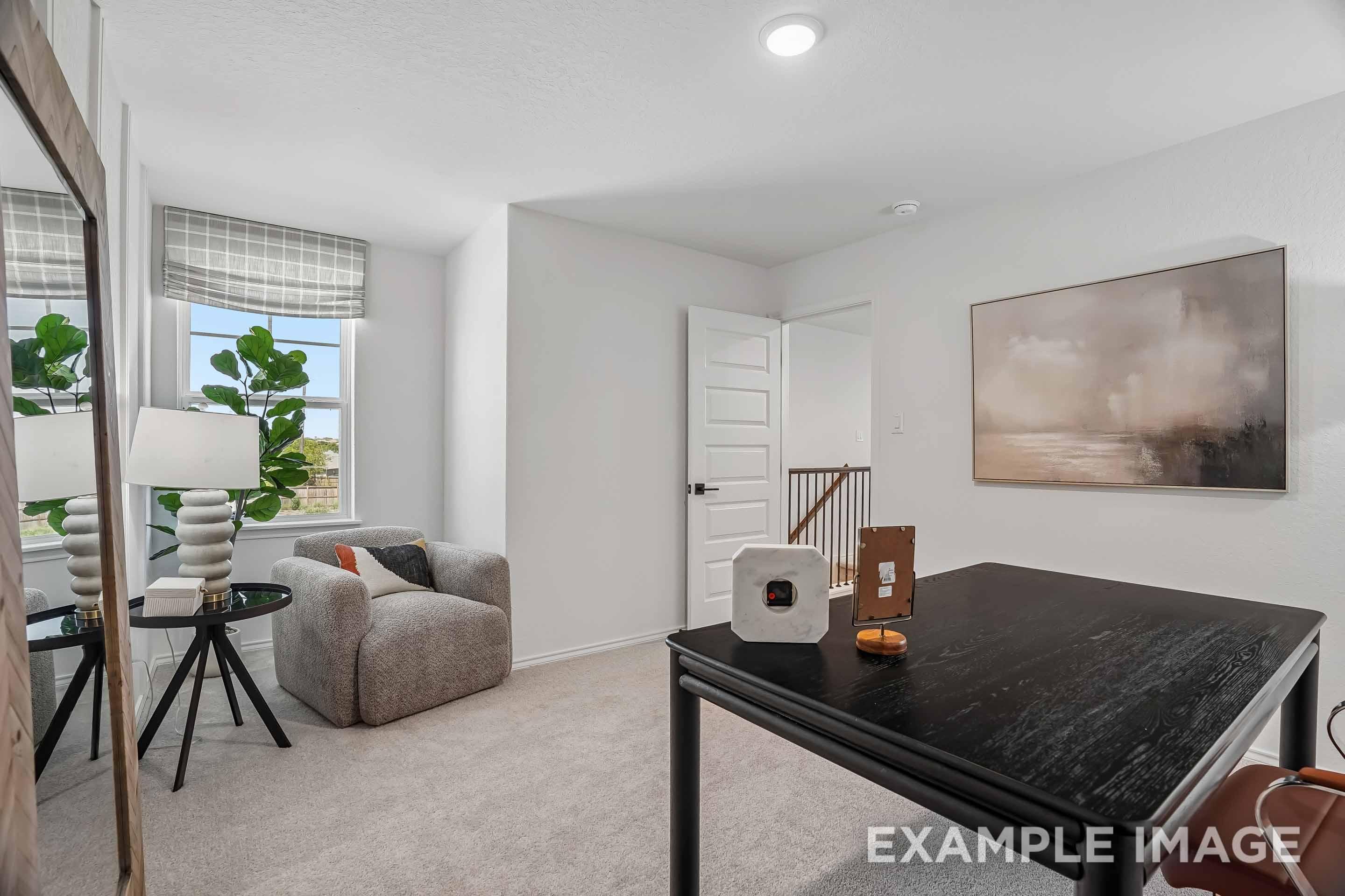 Bright home office in The Pinecrest D floor plan featuring a desk, cozy reading nook, and large window in San Antonio, TX.