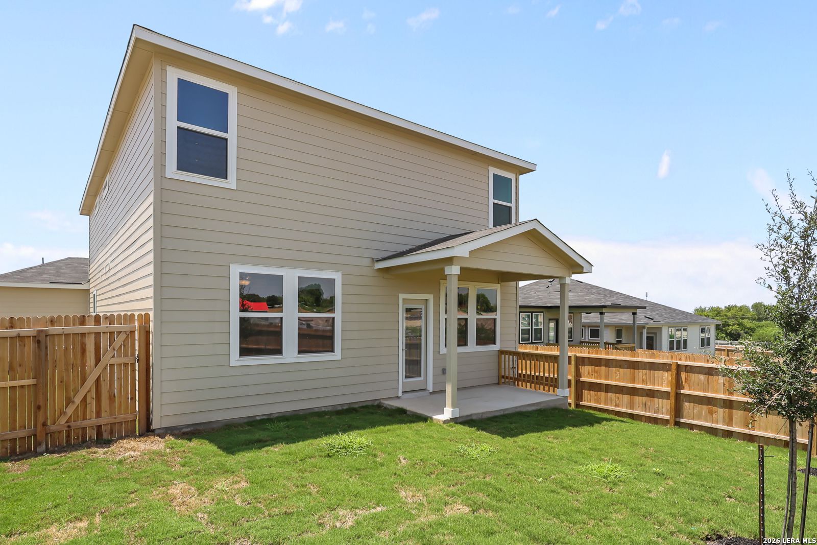 Two-story Davidson Homes San Marcos F floor plan with covered back patio and fenced yard in Rayburn Valley, San Antonio.
