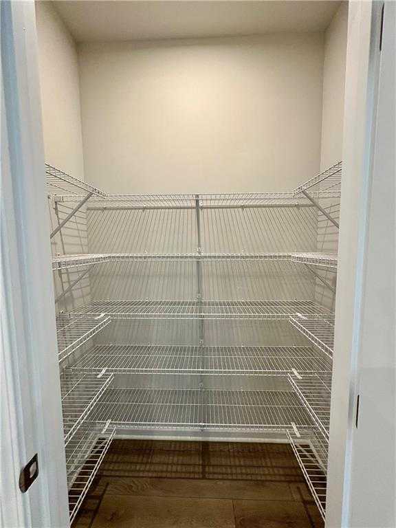 Spacious walk-in closet with wire shelving in master suite of Davidson Homes The Monroe B, Stegall Village, Emerson, Georgia