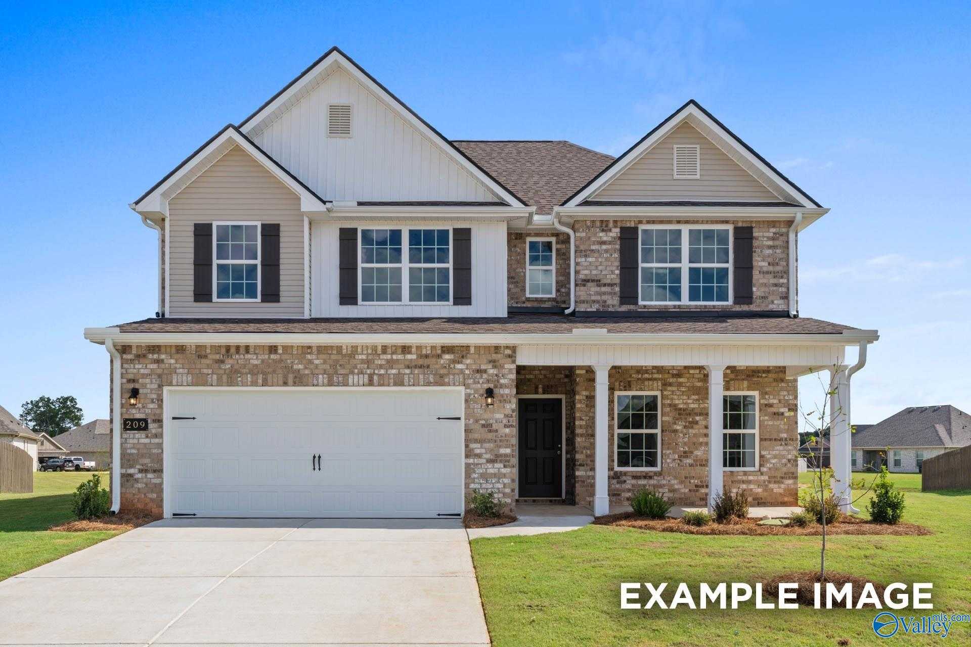 Two-story 4-bedroom home with beige brick exterior, gabled roof, front porch, and two-car garage in Ricketts Farm, Athens, Alabama