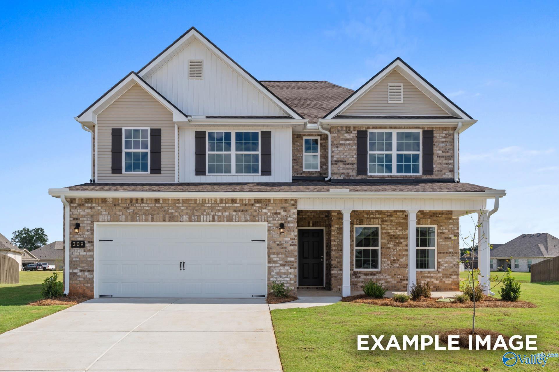 Two-story 4-bedroom home with beige brick exterior, gabled roof, front porch, and two-car garage in Ricketts Farm, Athens, Alabama