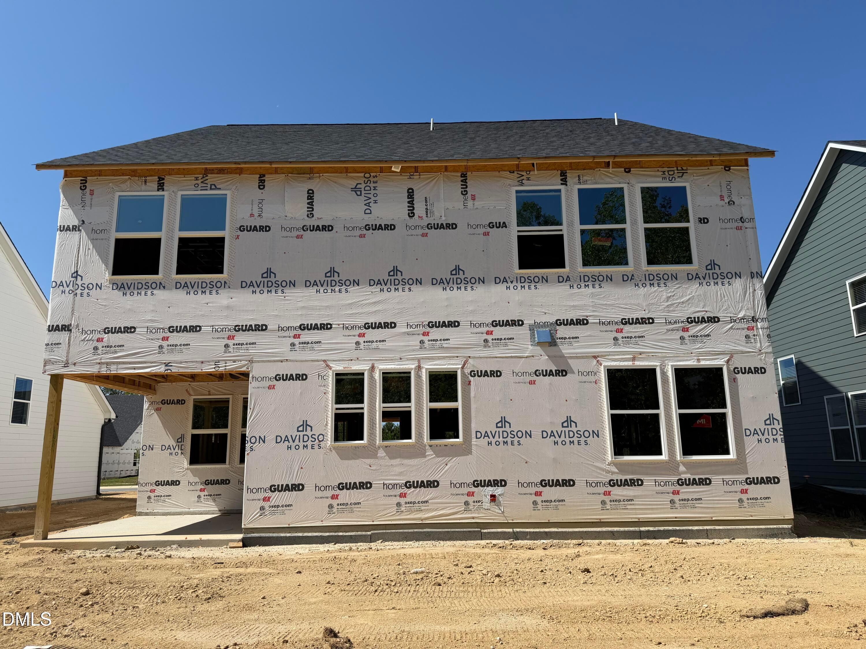 Two-story Davidson Homes Aspen C house under construction with windows and wrap in Wendell Ridge, Wendell, North Carolina