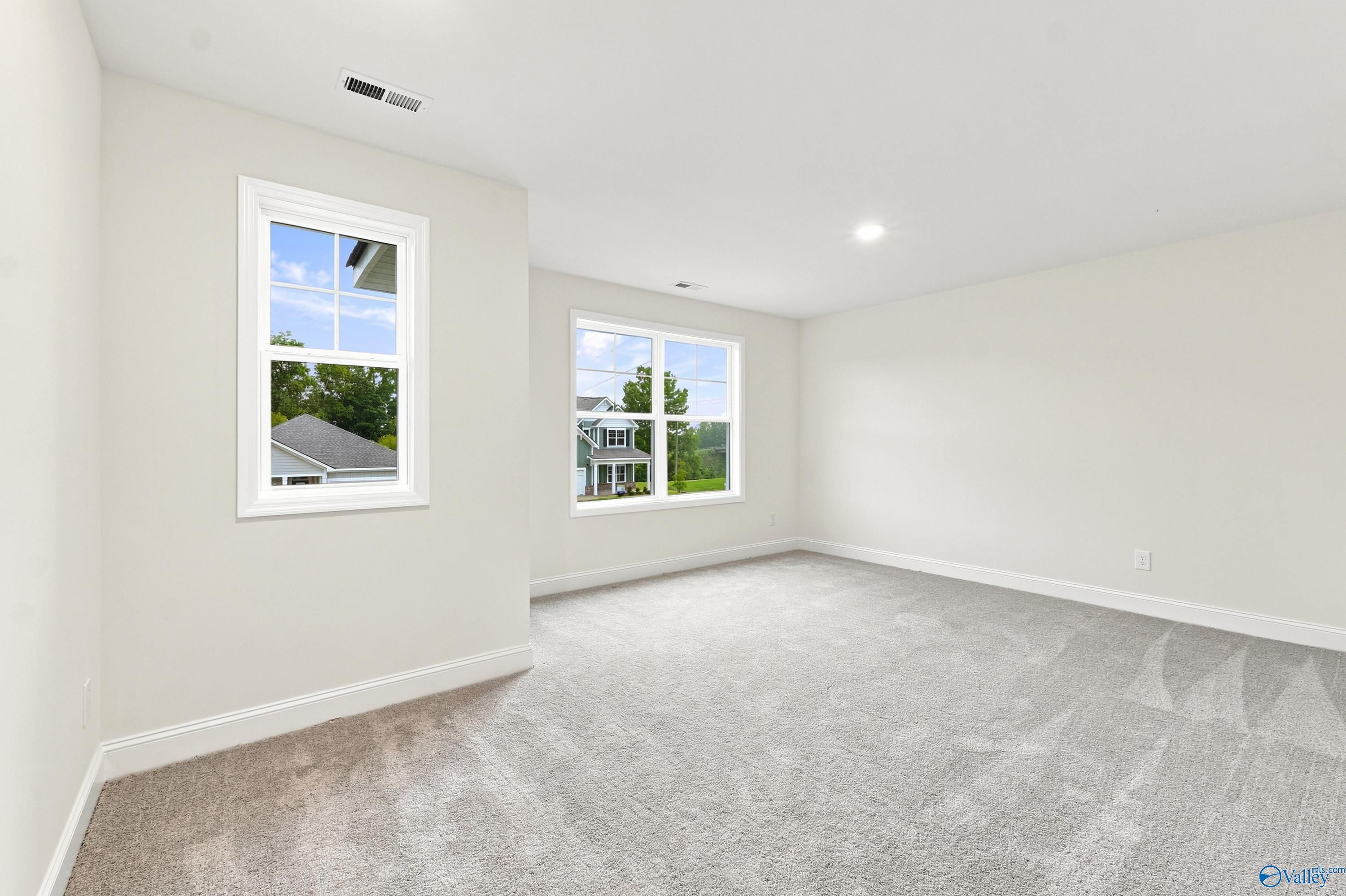 Spacious, light-filled bedroom with neutral carpet in The Shelby D floor plan at Noble Ridge, Cullman, Alabama.