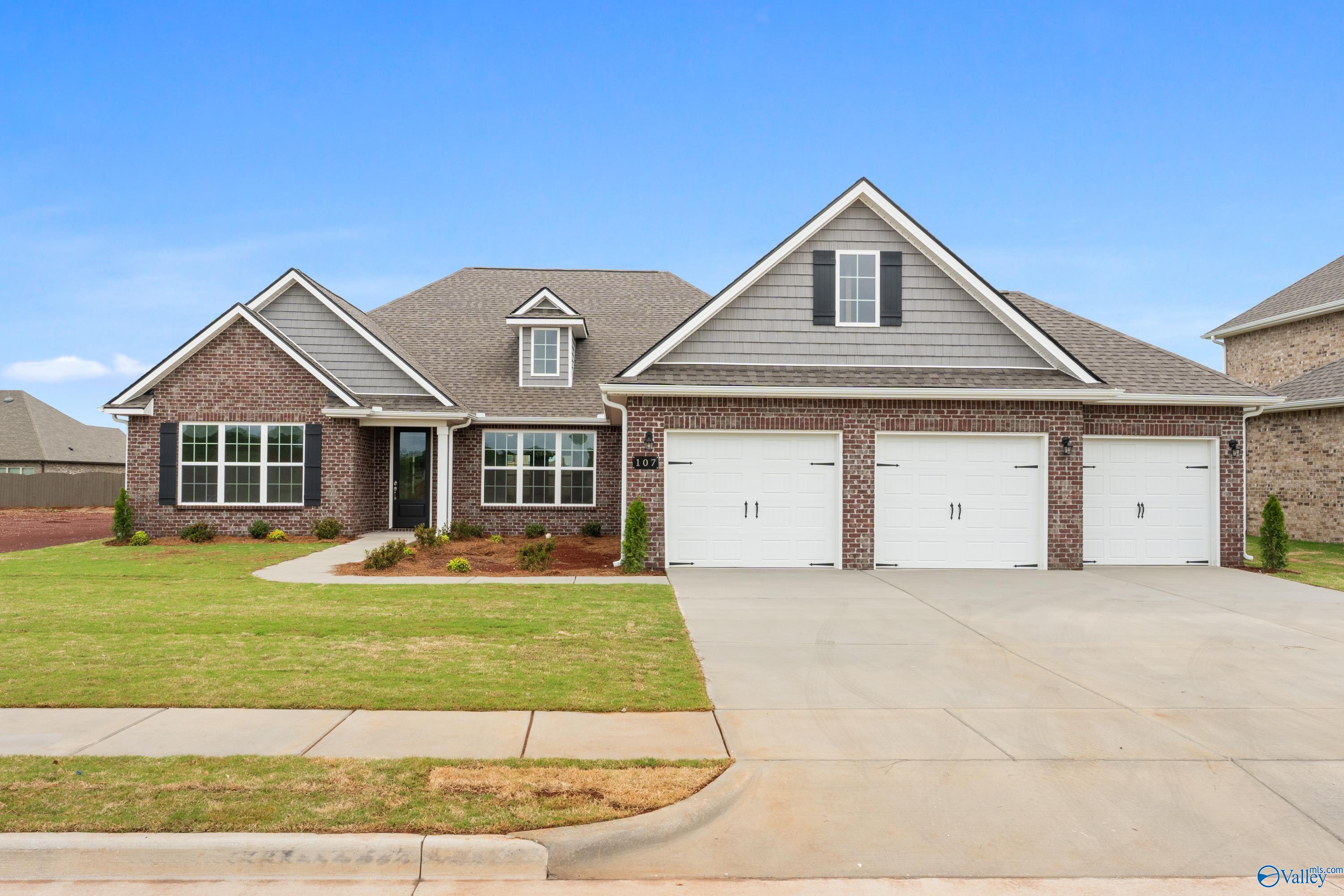 Modern 1-story brick home with shingled roof, 2-car garage, and landscaped front yard in Briercreek, Meridianville, Alabama