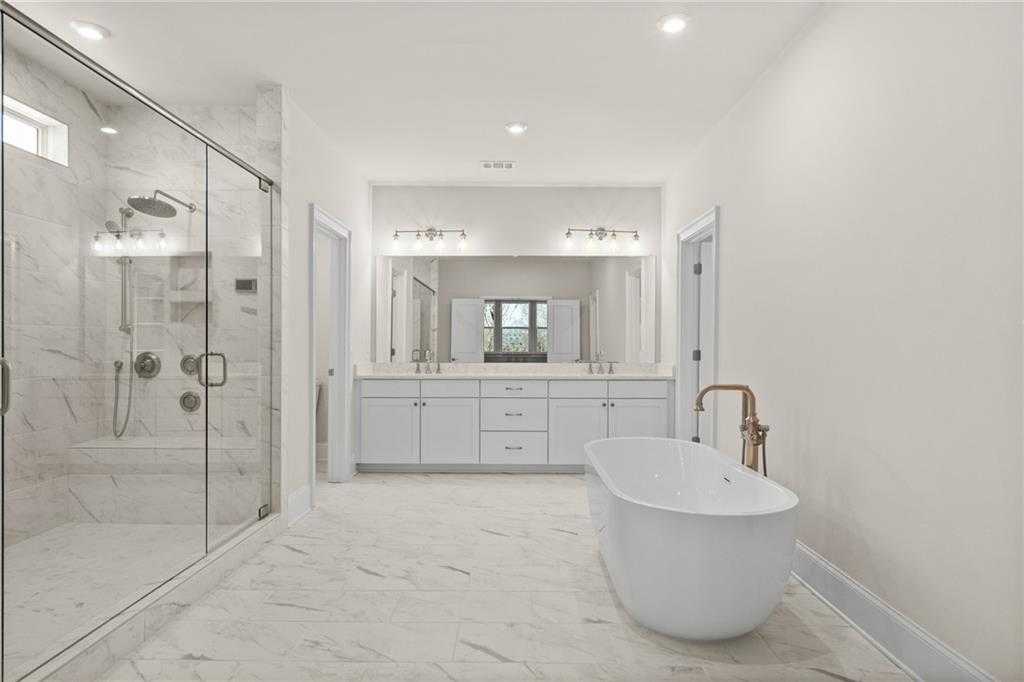 Luxurious master bathroom with freestanding tub, double vanity, glass shower in Davidson Homes The Arlington A, East Cobb, Georgia
