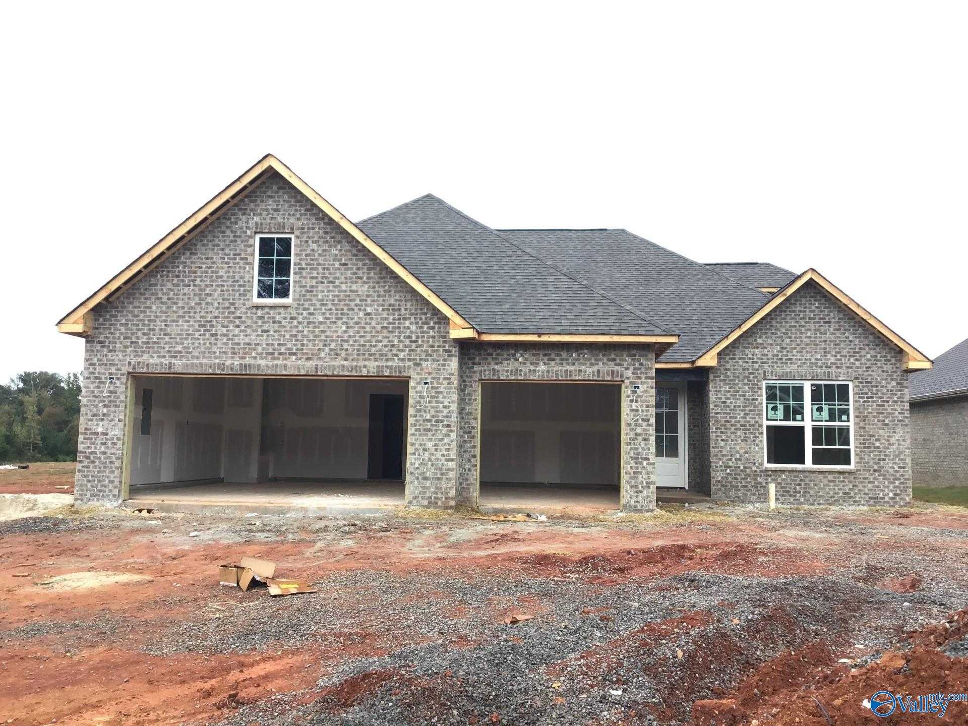 Single-story brick ranch home with open 2-car garage, gabled gray roof, The Kirkland plan by Davidson Homes in River Road Estates, Decatur, Alabama