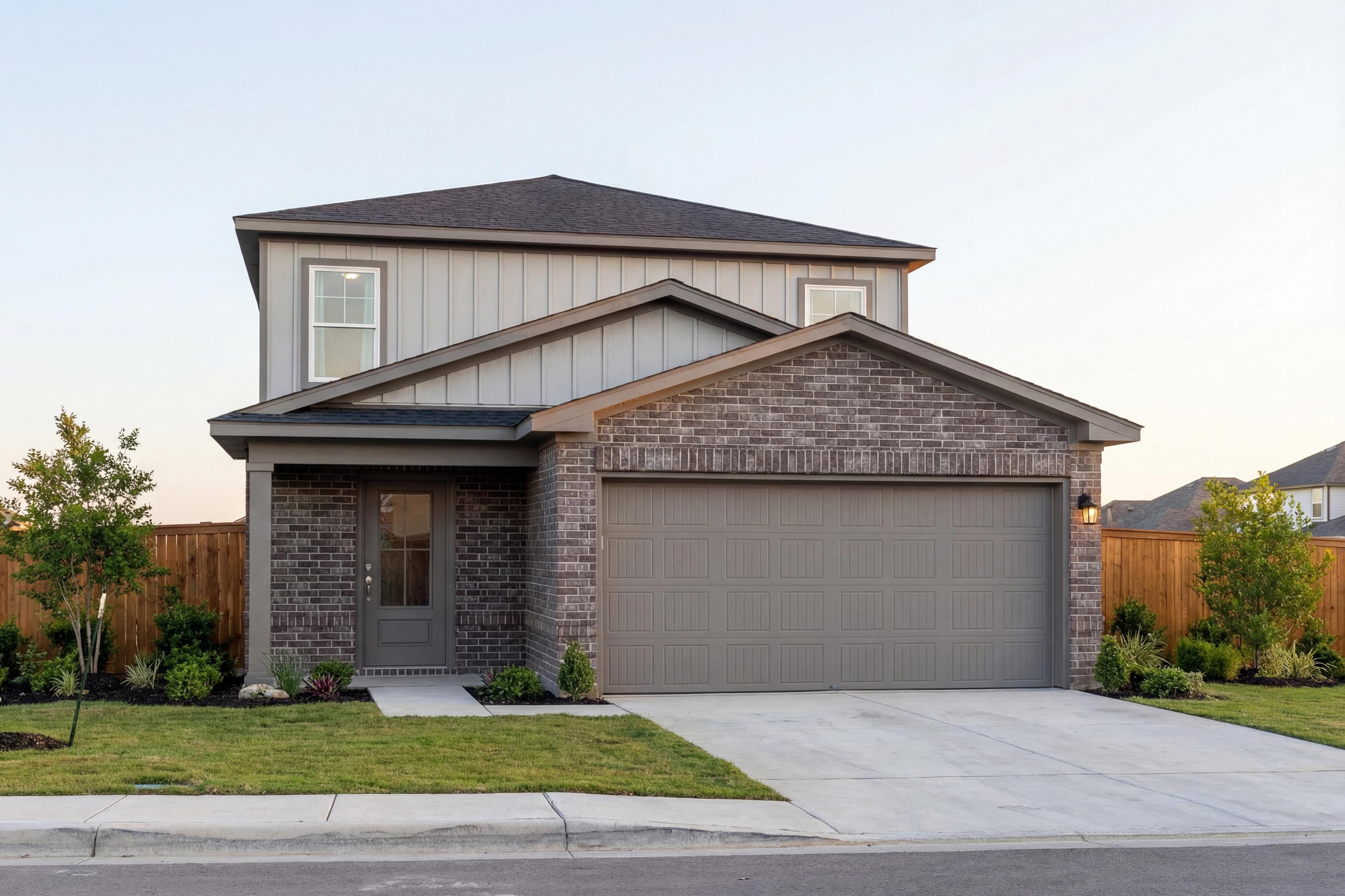 Two-story San Marcos home elevation by Davidson Homes with brick facade, gray siding, two-car garage, and covered porch in San Antonio