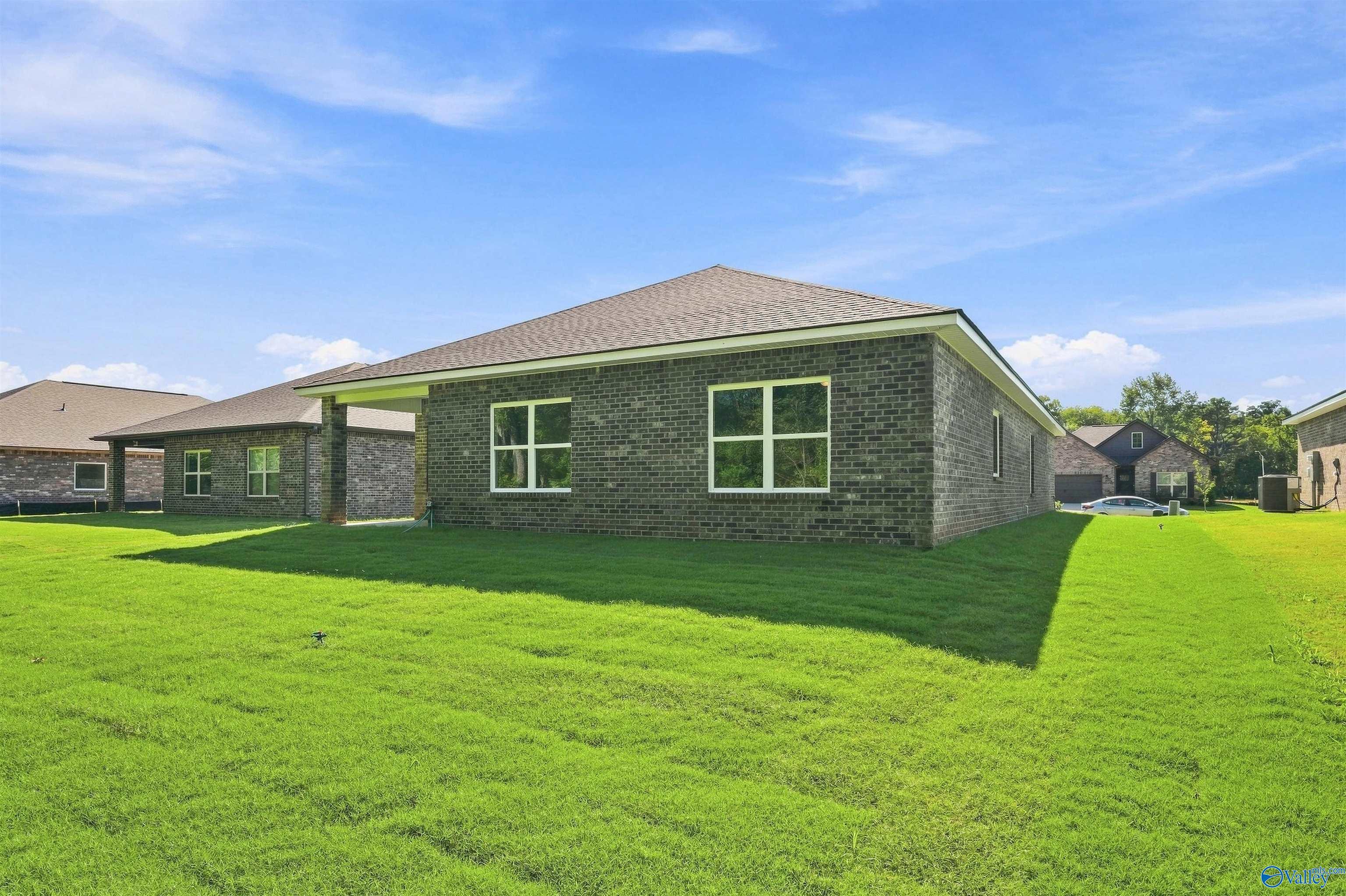 Back view of The Daphne floor plan by Davidson Homes with brick exterior in Spragins Cove, Huntsville, Alabama.
