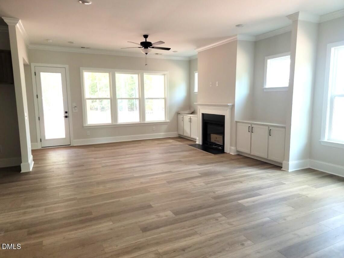 Bright great room with hardwood floors, fireplace, and built-ins in The Magnolia II B by Davidson Homes, Wake Forest, NC