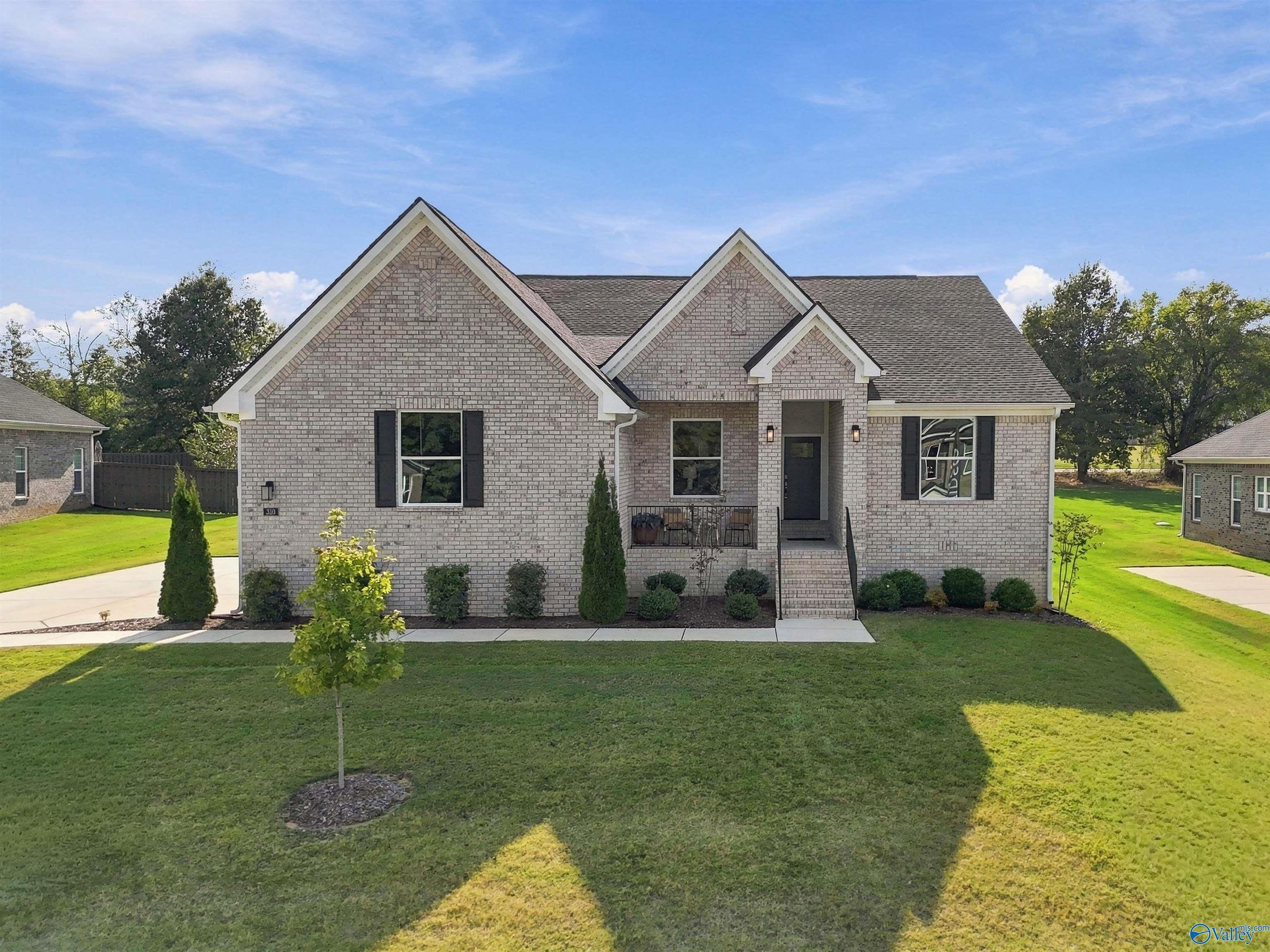 Brick front exterior of Davidson Homes' 4-bedroom Arcadia E floor plan with gabled roof in Riverton Preserve, Huntsville, Alabama