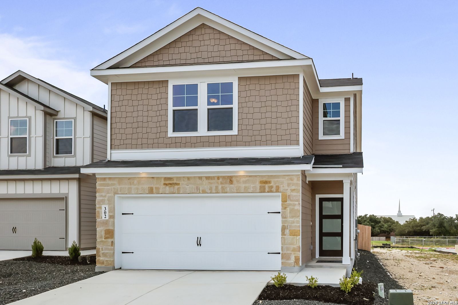 Two-story Florence B floor plan by Davidson Homes with stone facade and 2-car garage in Meadows at Oak Creek, San Antonio.