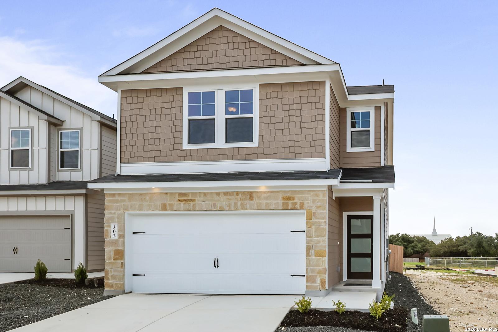 Two-story Florence B floor plan by Davidson Homes with stone facade and 2-car garage in Meadows at Oak Creek, San Antonio.