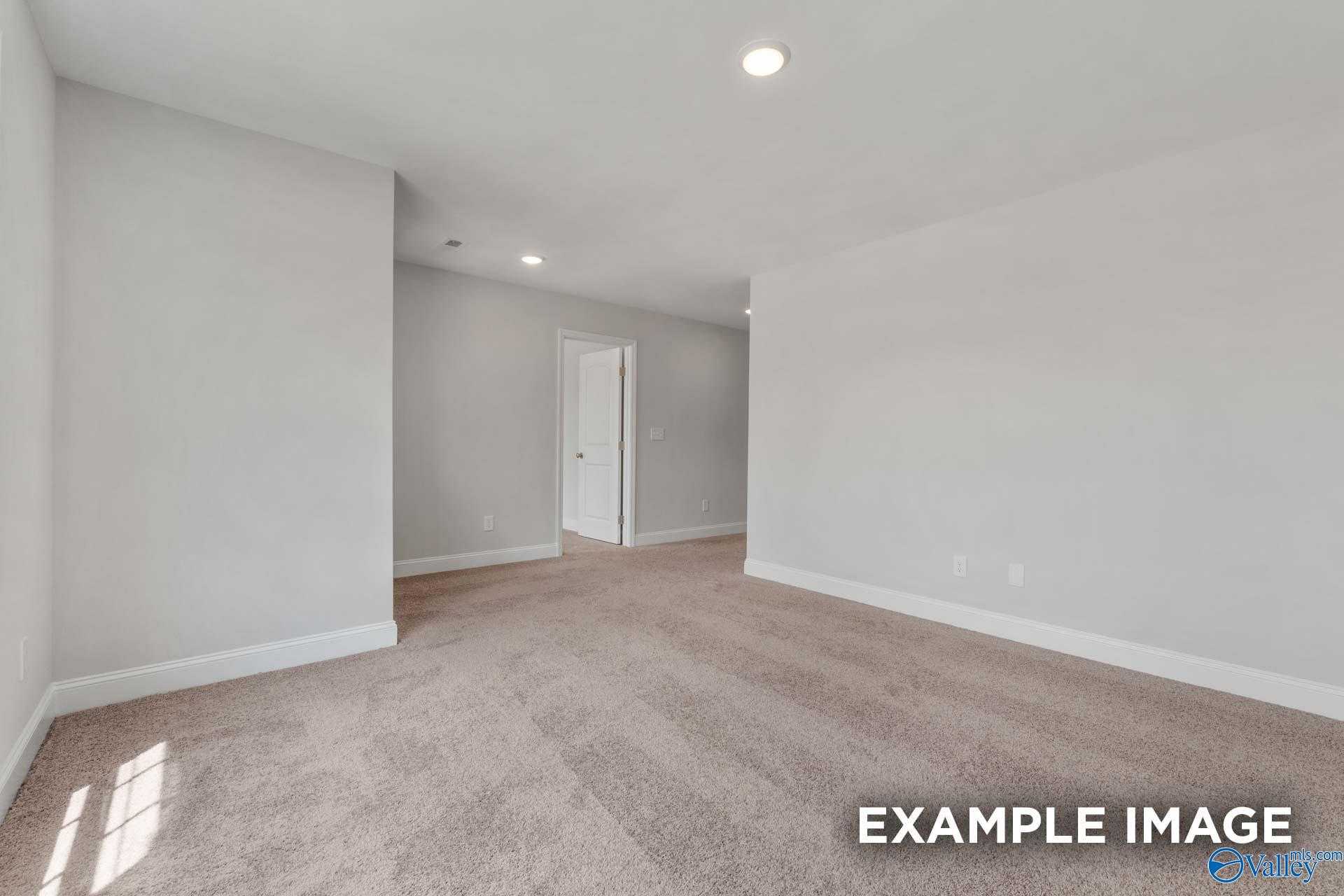 Modern bedroom with light gray walls, beige carpet, recessed lights in Davidson Homes Shelby C, Meridianville AL