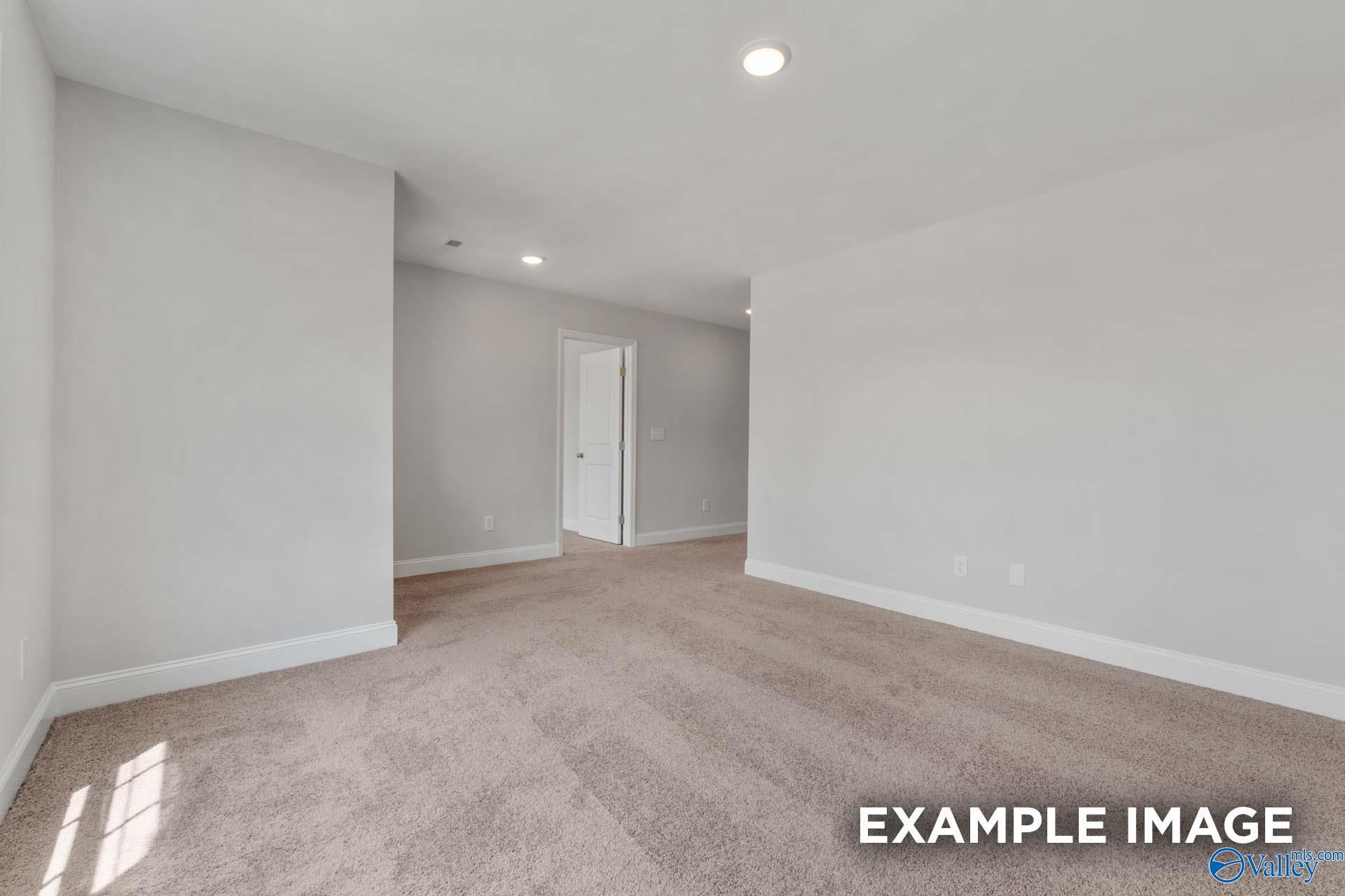 Modern bedroom with light gray walls, beige carpet, recessed lights in Davidson Homes Shelby C, Meridianville AL