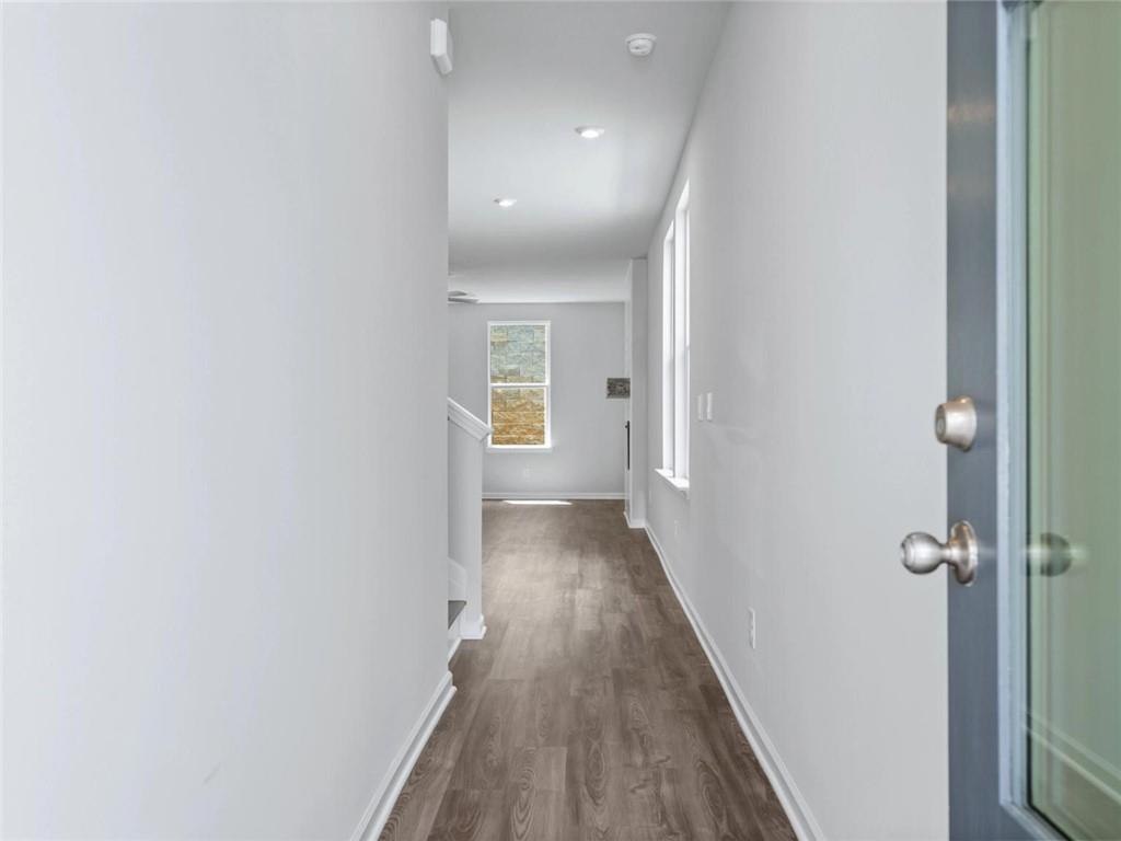 Bright entryway and hallway leading into The Cary A floor plan at Lake Shore in Winder, Georgia.