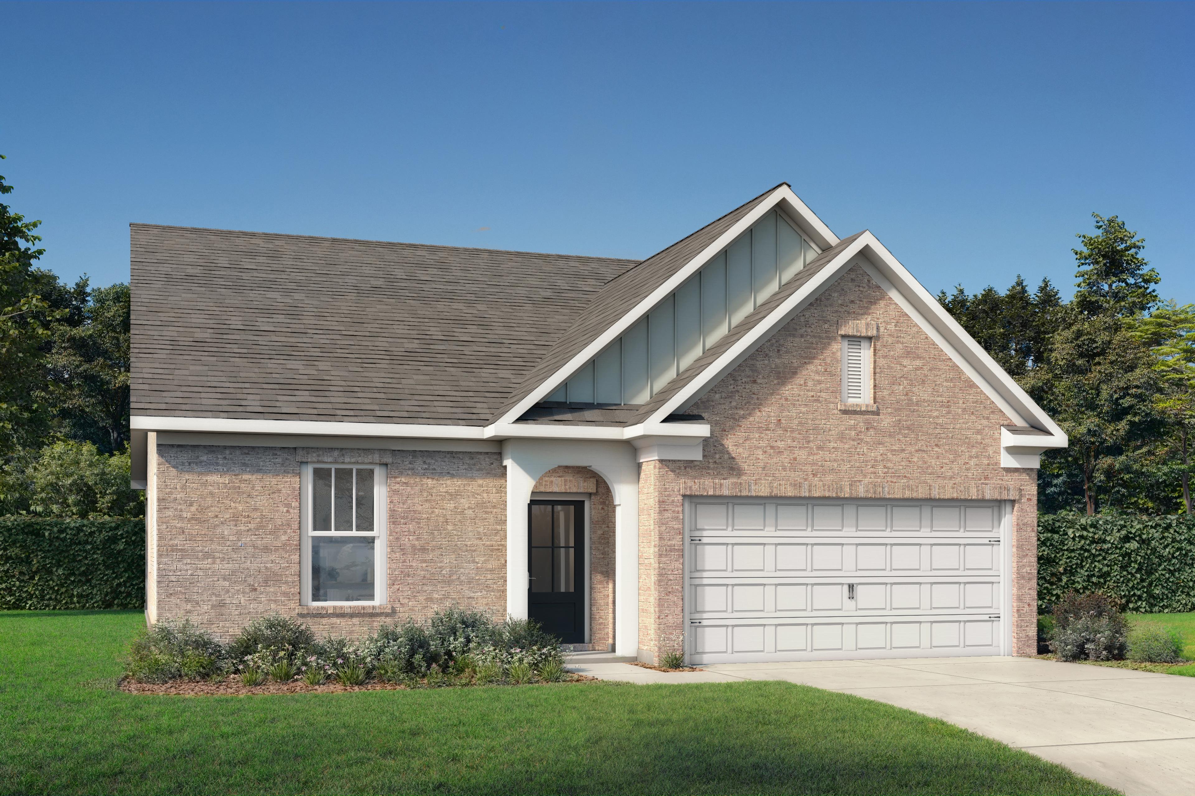 Single-story brick facade of The Prairie C home with gabled roof, arched porch, 2-car garage, and lush landscaped yard in Gallatin, TN