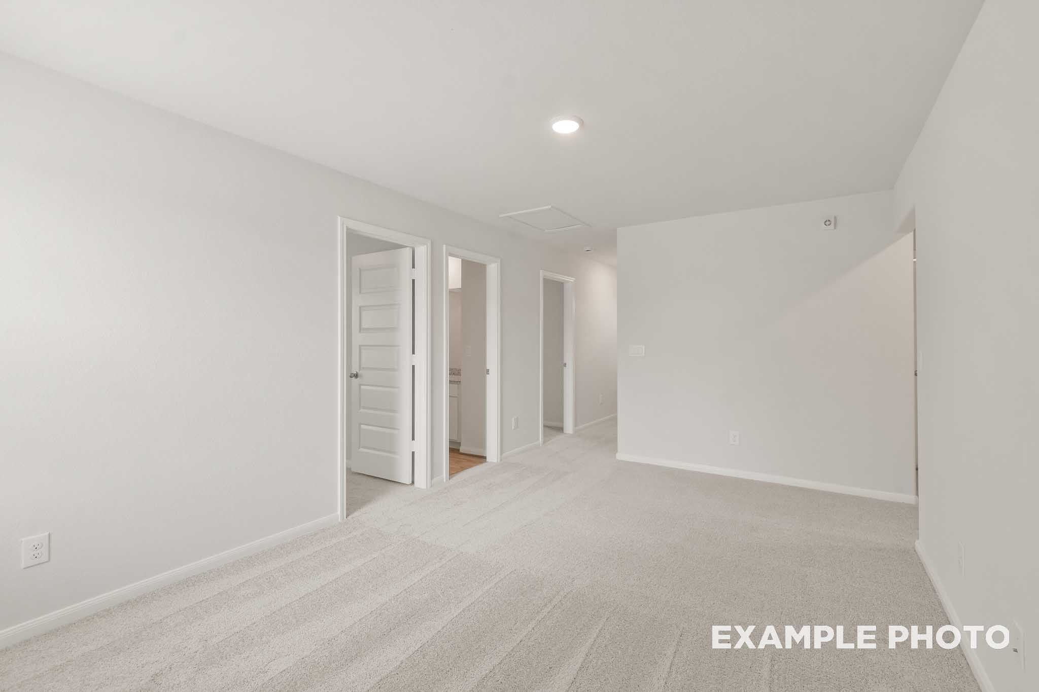 Spacious carpeted bedroom in The Brazos by Davidson Homes, Beasley TX new construction home with neutral white interior