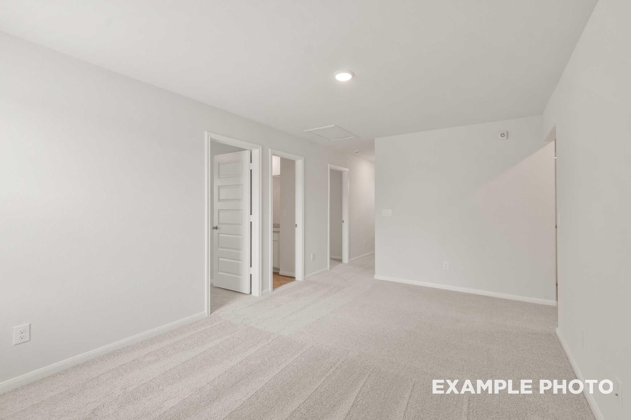 Spacious carpeted bedroom in The Brazos by Davidson Homes, Beasley TX new construction home with neutral white interior