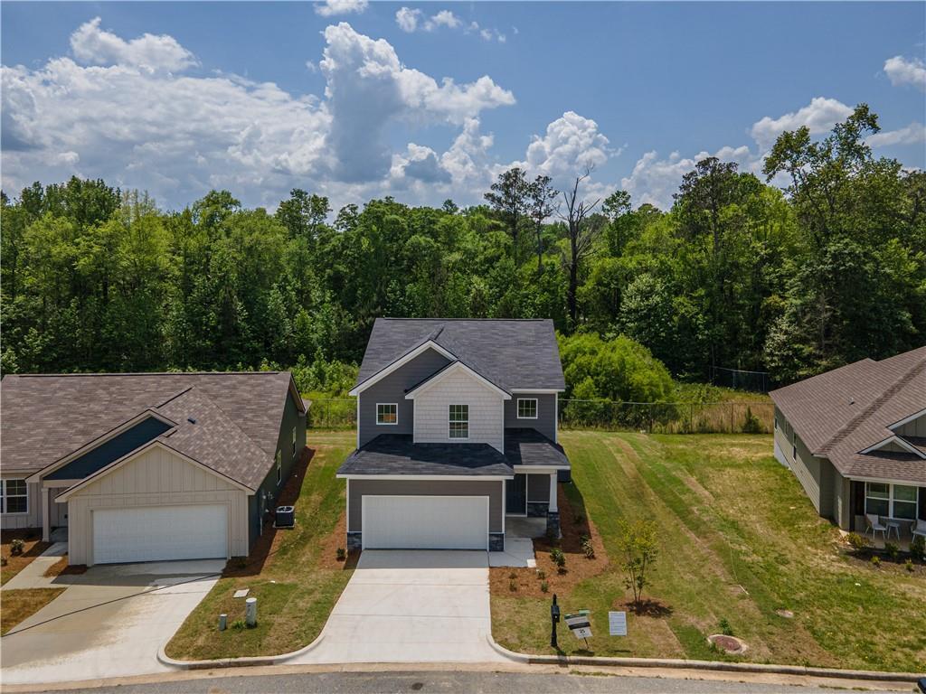 Two-story gray home with 2-car garage and driveway in wooded Summer Vineyard neighborhood, Phenix City, Alabama - Davidson Homes Bartlett