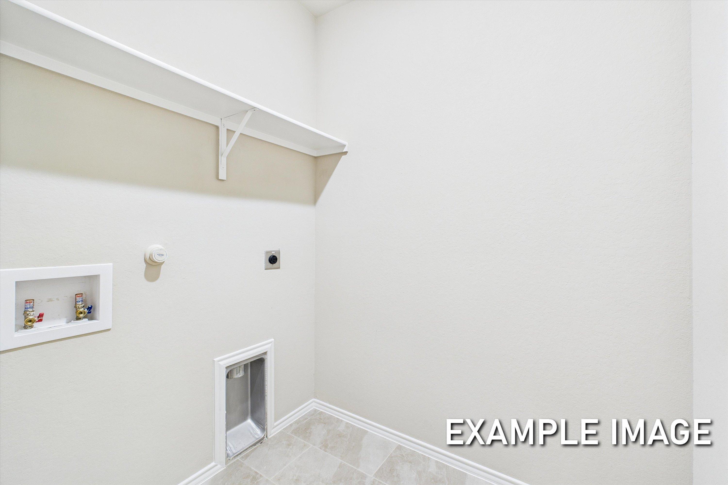 Dedicated laundry room in The Comal A floor plan featuring washer and dryer hookups and overhead shelving.