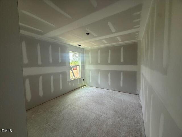 Unfinished bedroom with drywall and tray ceiling in The Birch II A floor plan at Montrose in Aberdeen, North Carolina.