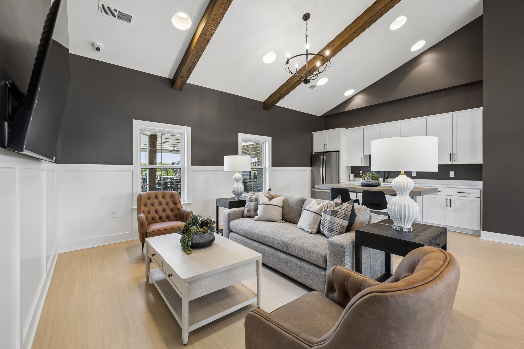 Open-concept clubhouse lounge at Bradshaw Farms in Mt. Juliet, TN with vaulted ceilings, exposed beams, and modern kitchen.