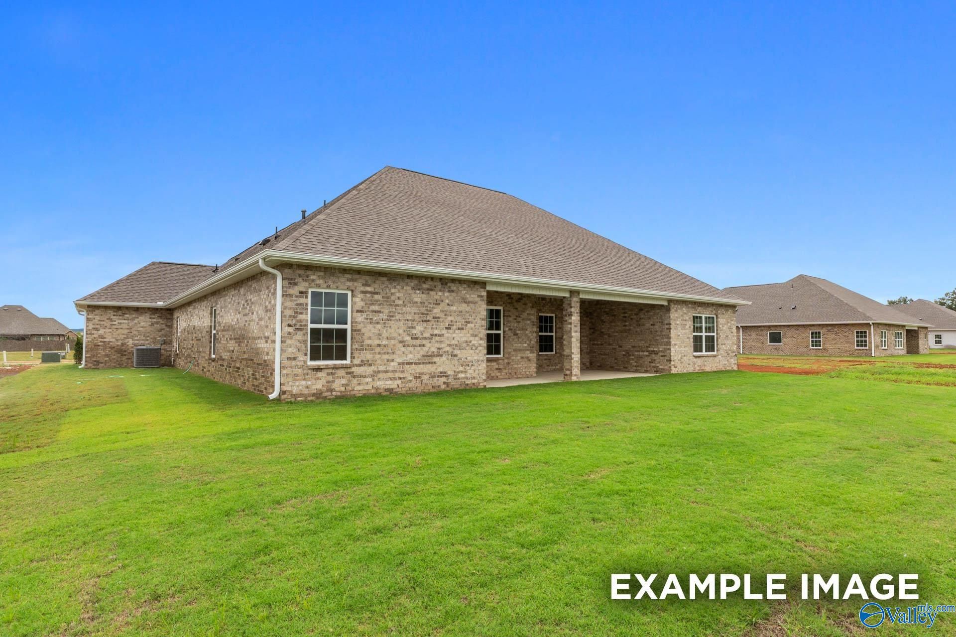 Two-story brick Emory home with shingled roof, covered patio, and lush green lawn in Kendall Farms, Toney, Alabama