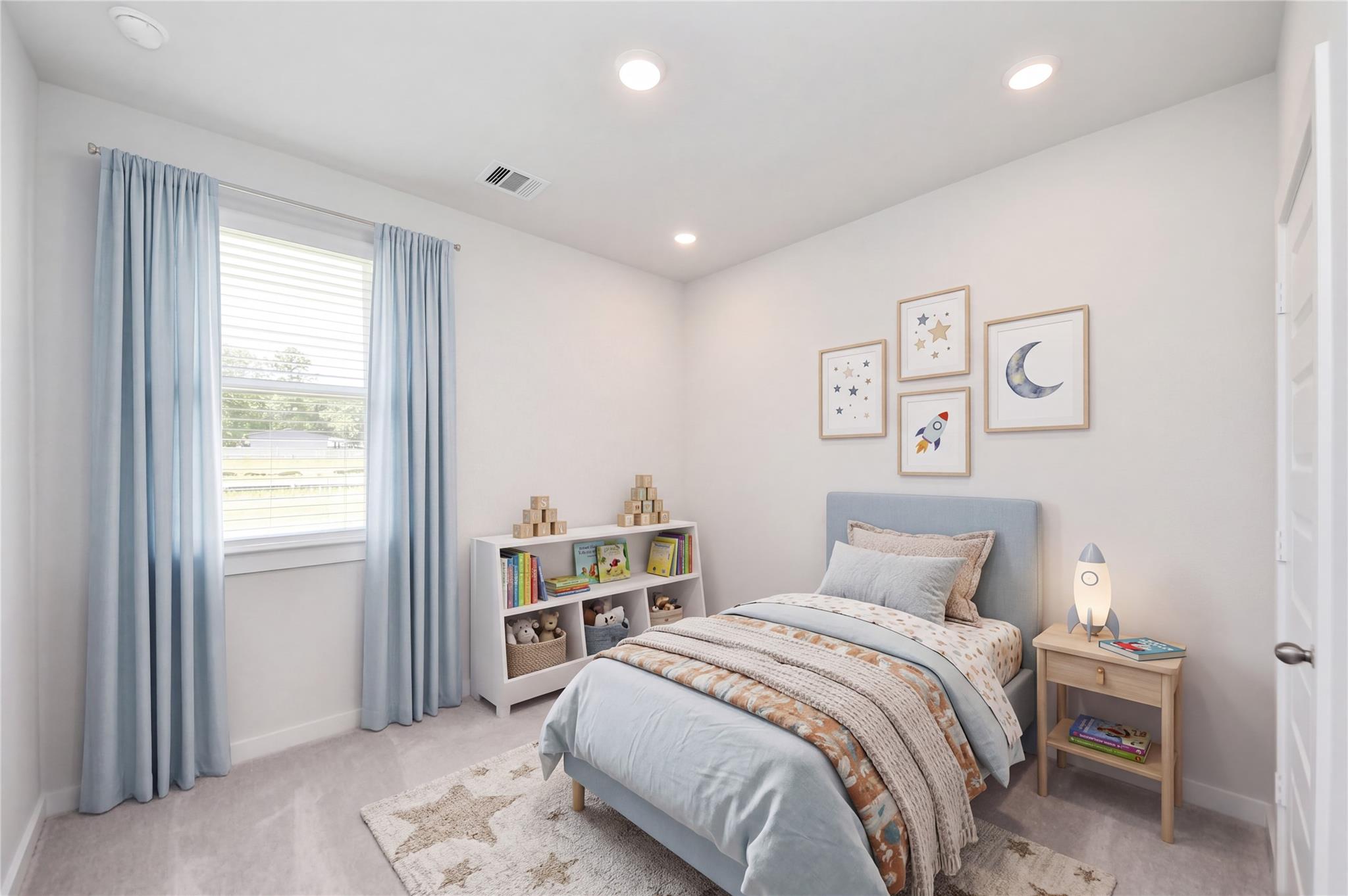 Bright bedroom with blue accents and bookshelf in Davidson Homes' Frio F plan at Liberty Estates, Cleveland, Texas