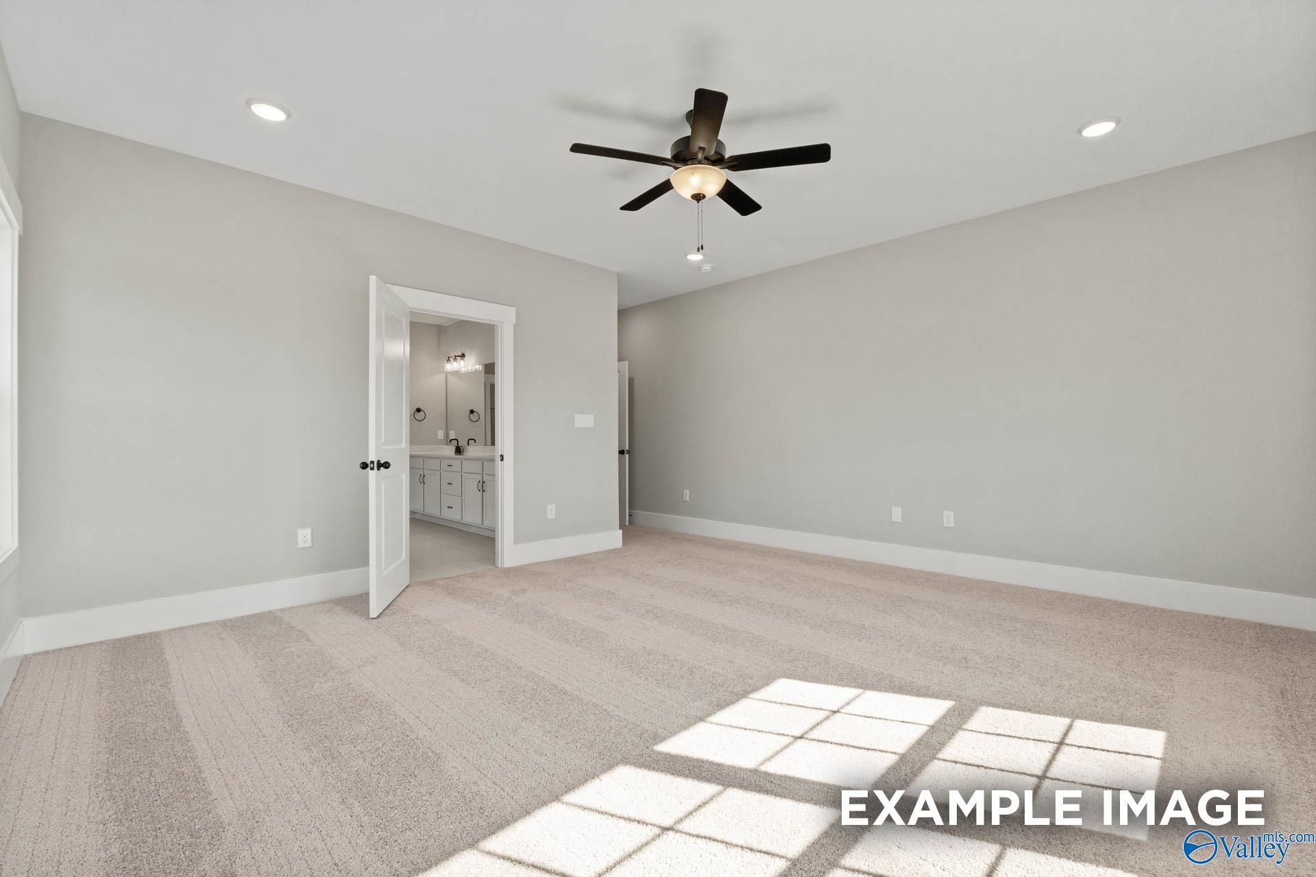 Spacious primary bedroom with ceiling fan and en-suite bathroom in Davidson Homes The Finleigh floor plan, Meridianville.