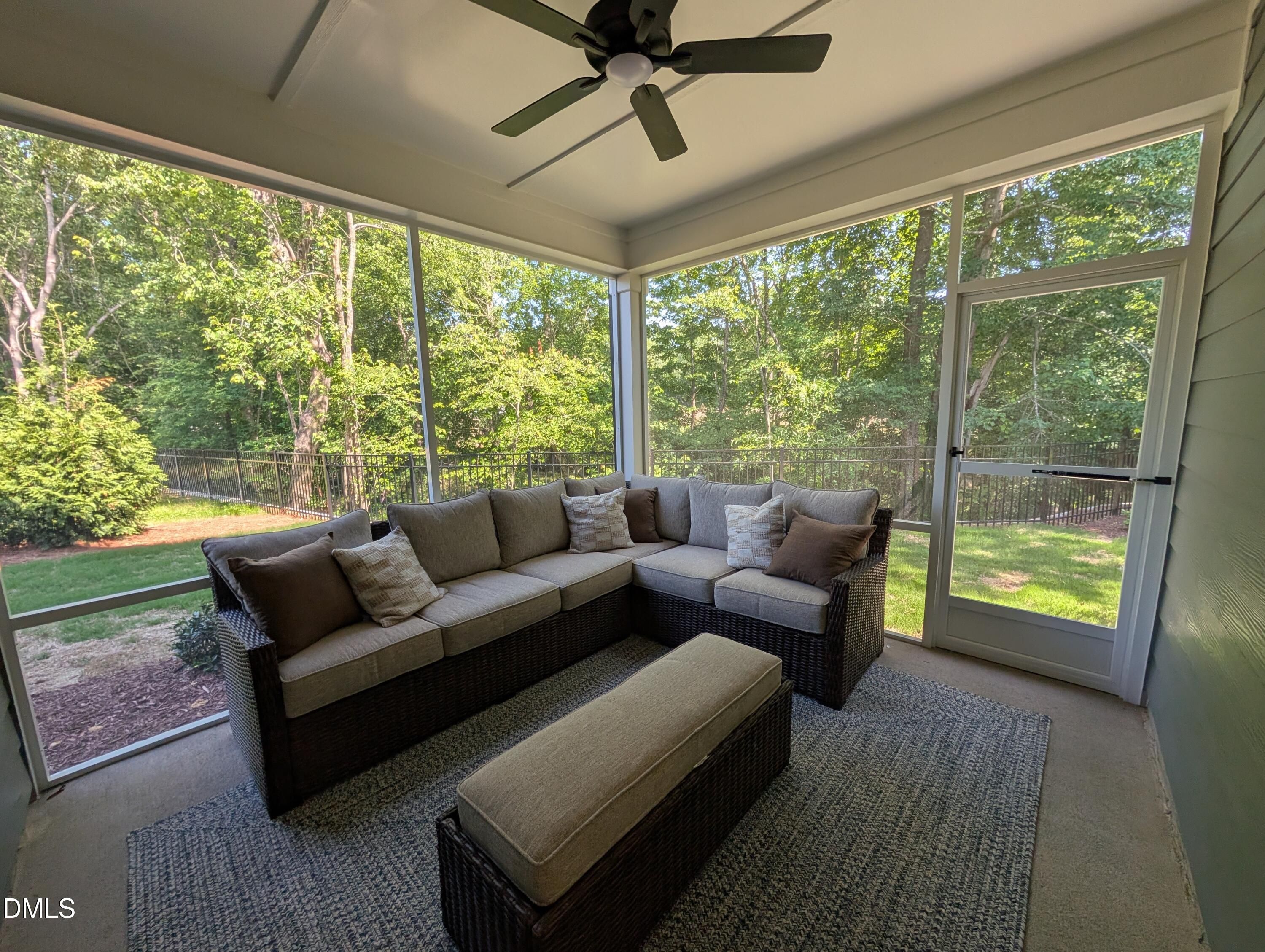 Screened-in porch with sectional seating in The Aspen B floor plan at Wendell Ridge, Wendell, North Carolina.