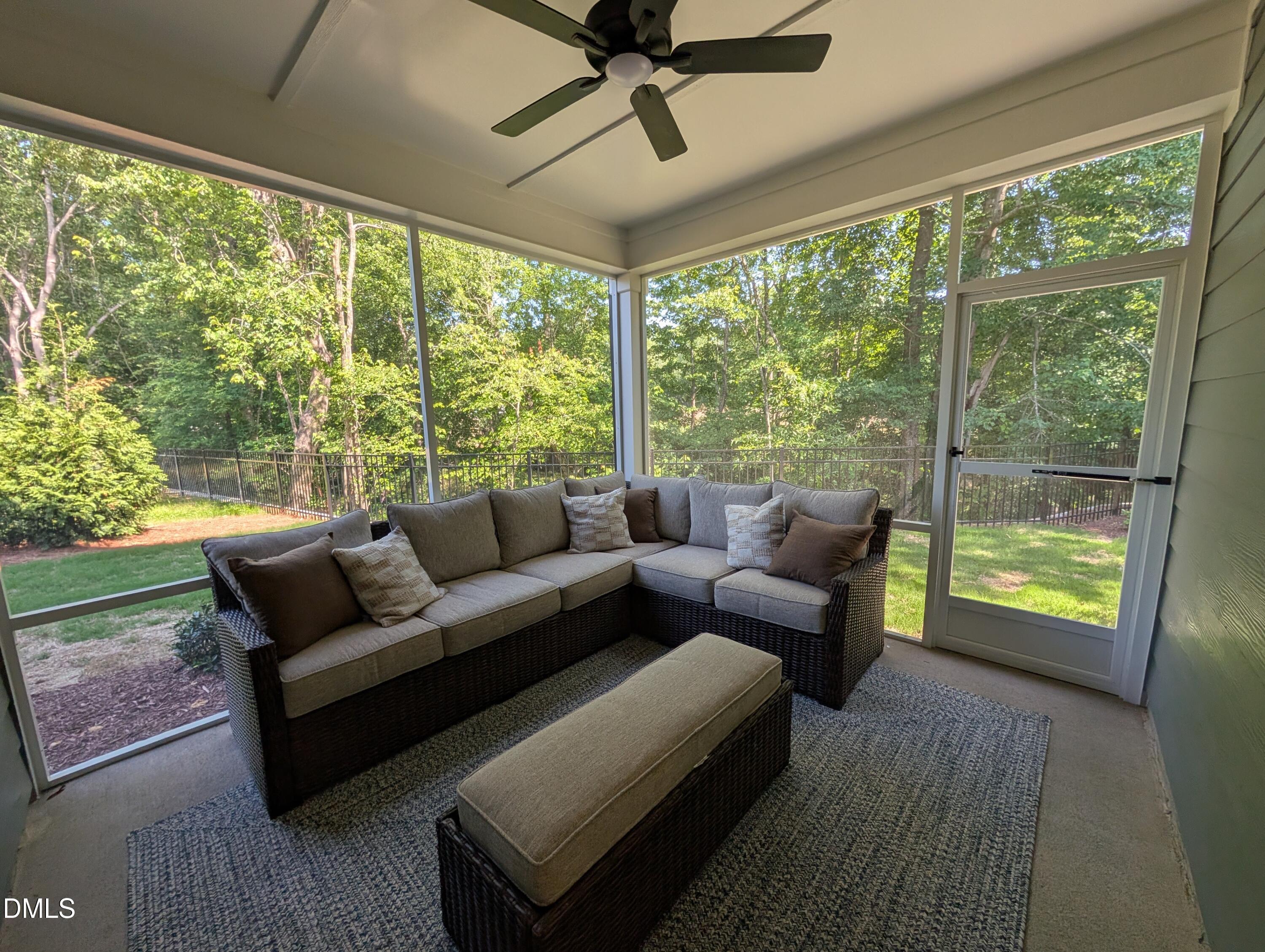 Screened-in porch with sectional seating in The Aspen B floor plan at Wendell Ridge, Wendell, North Carolina.