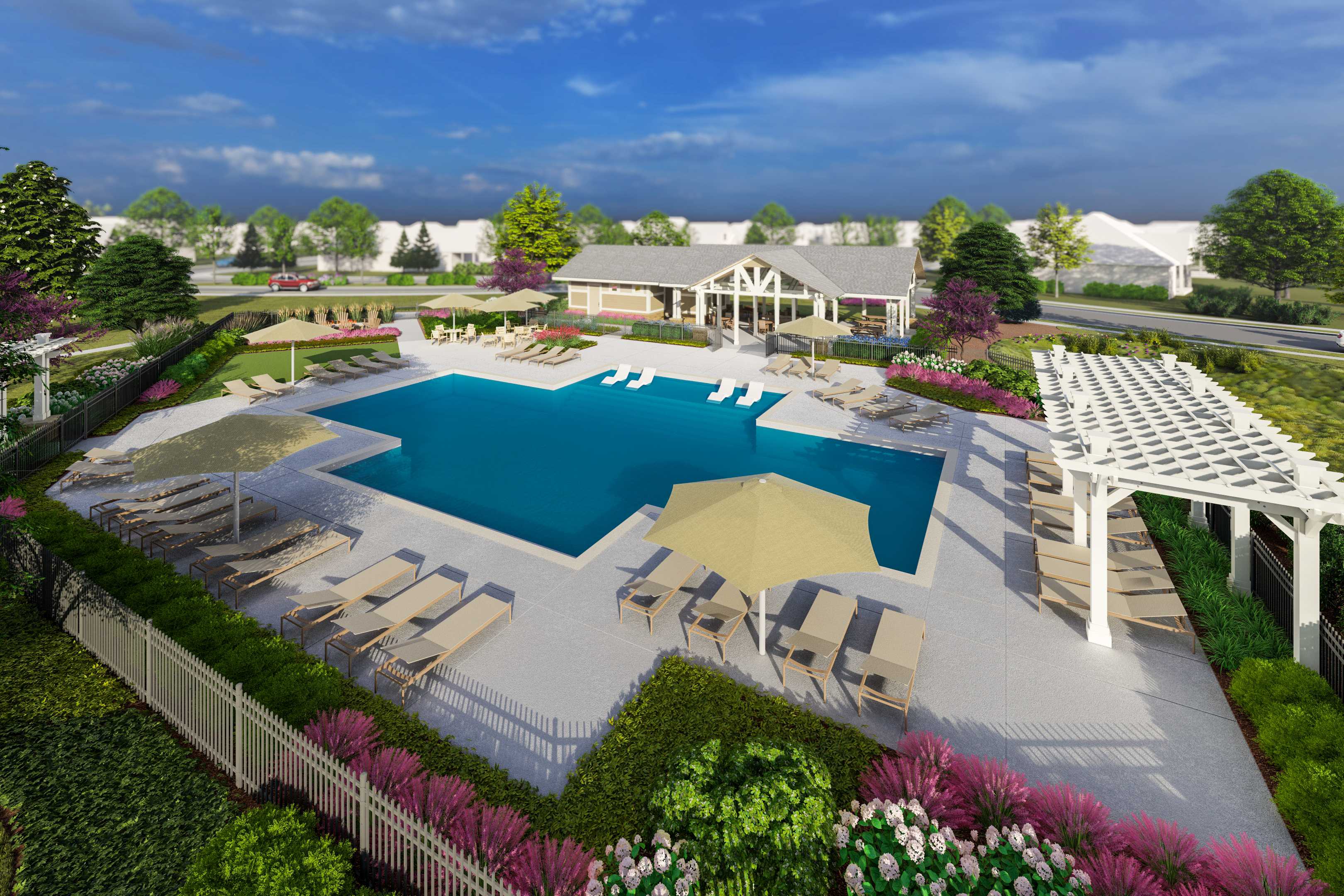 Community swimming pool at Creekside in Harvest, Alabama with chaise lounges, umbrellas, white pergola, and lush landscaping