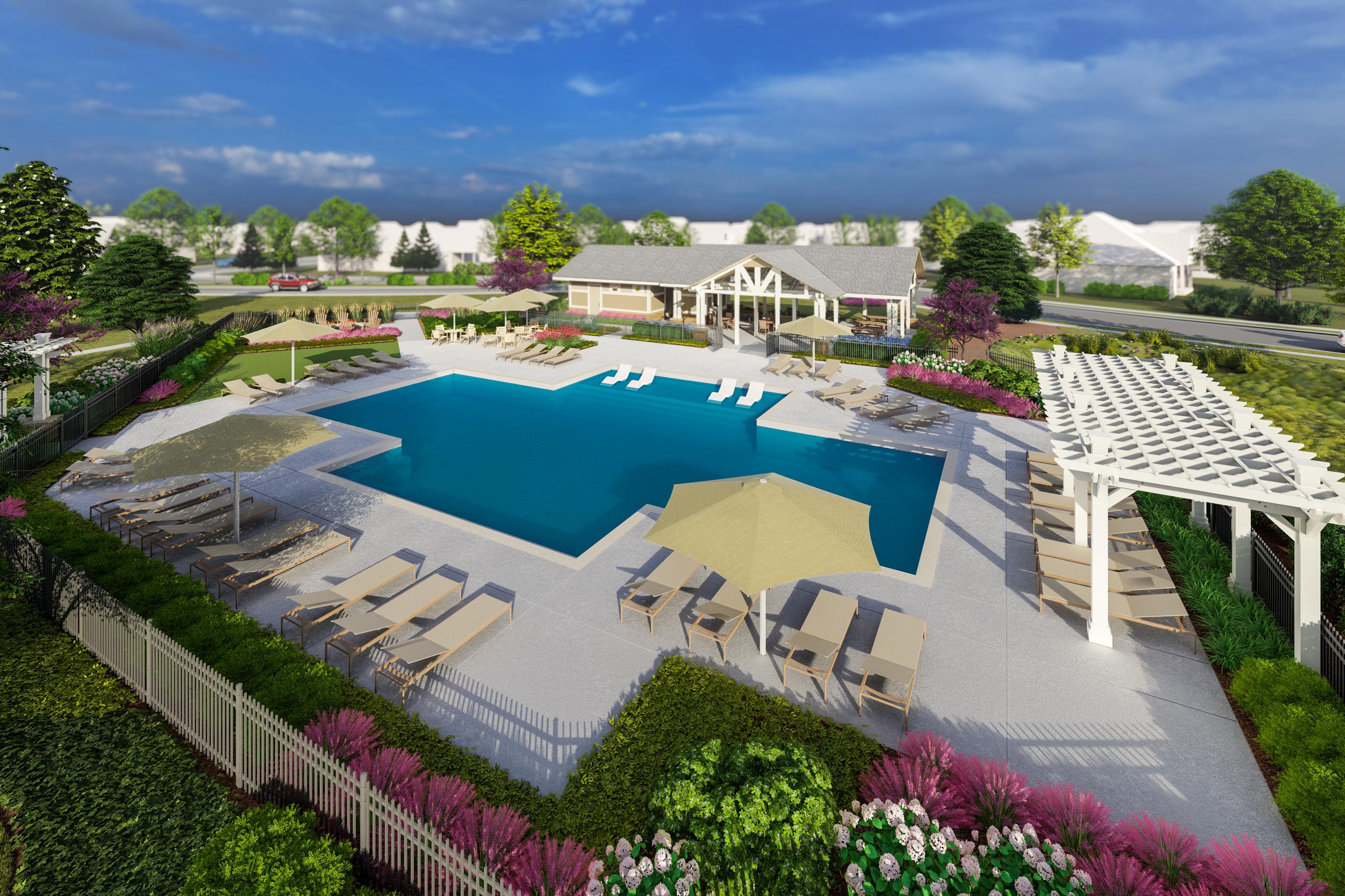Community swimming pool at Creekside in Harvest, Alabama with chaise lounges, umbrellas, white pergola, and lush landscaping