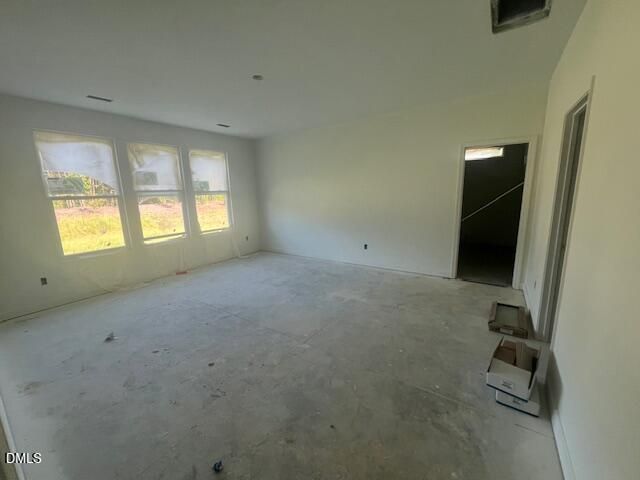 Unfinished great room with triple windows and open floor plan in Davidson Homes Magnolia II B, Lillington, North Carolina