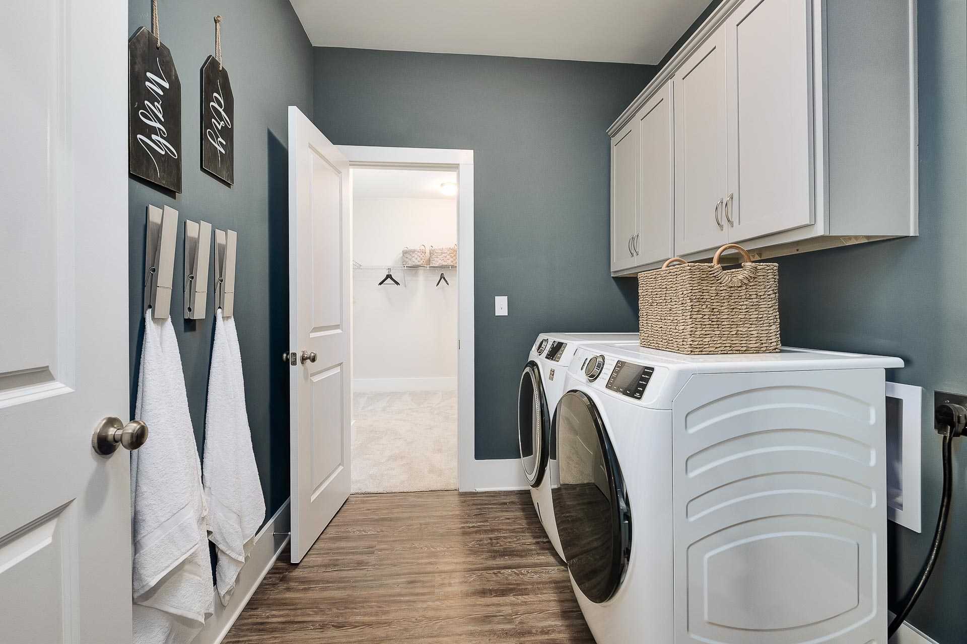 laundry room with white built-in cabinets in The Everett by Davidson Homes
