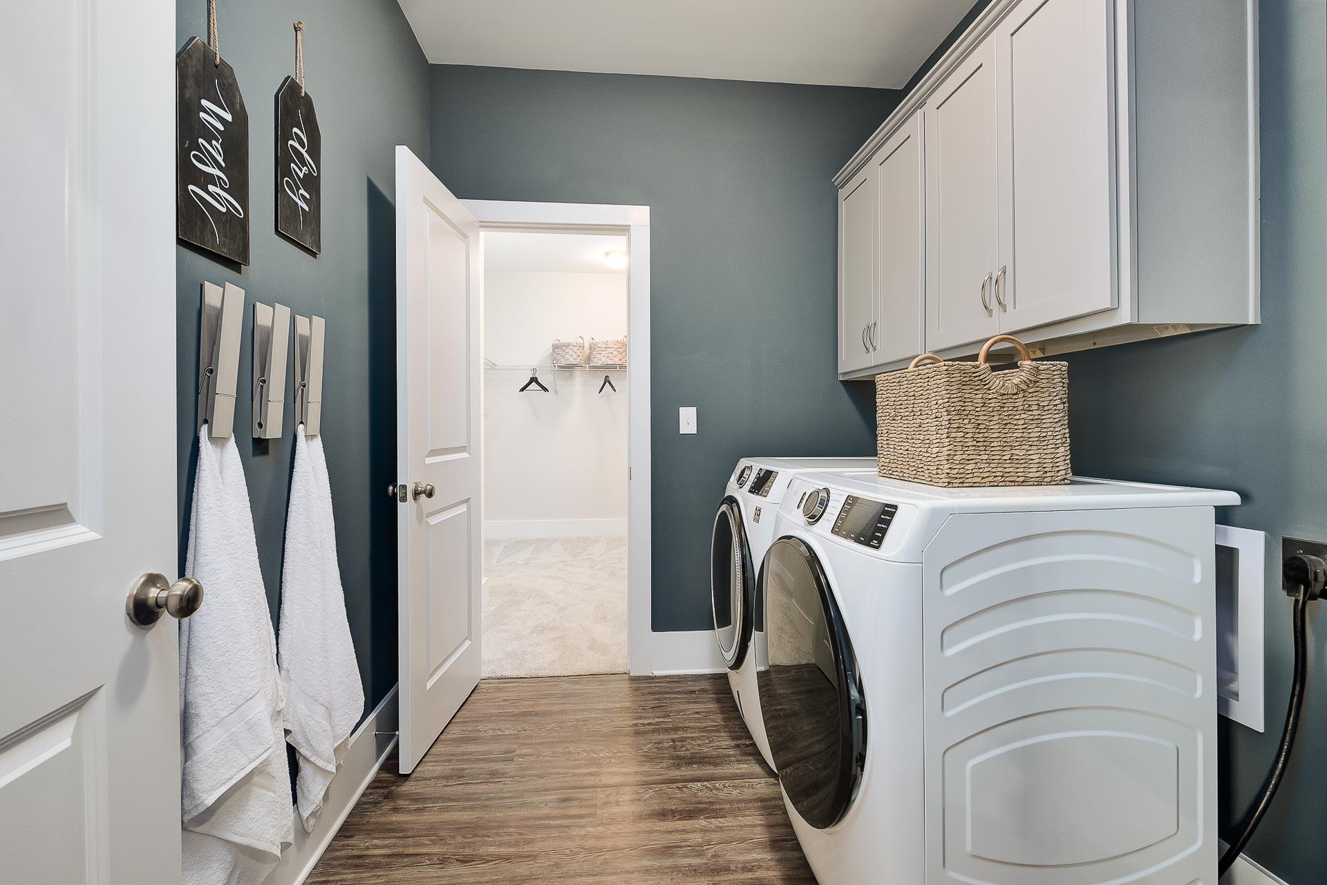 laundry room with white built-in cabinets in The Everett by Davidson Homes