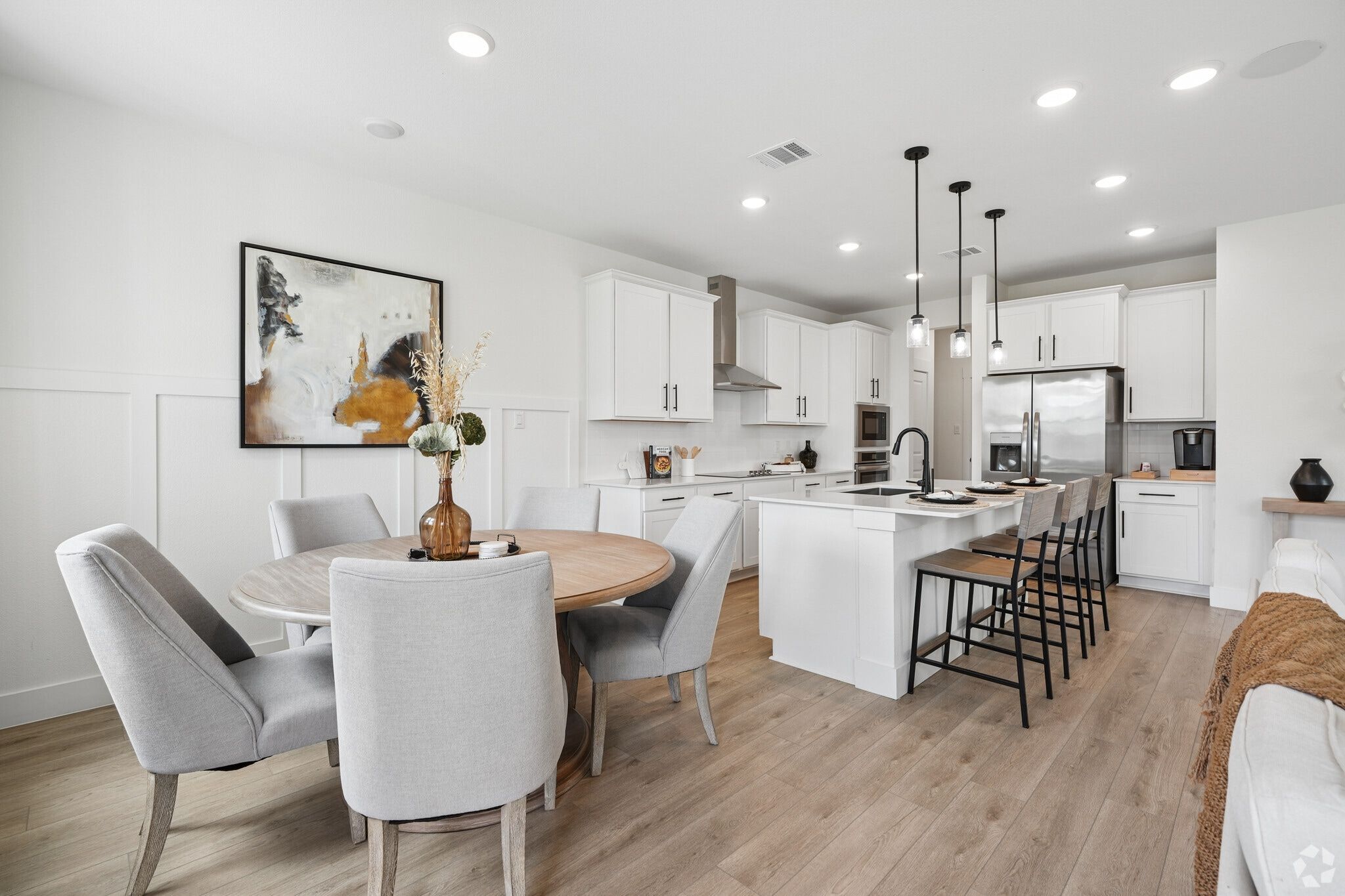 Cozy breakfast adjacent to open-concept kitchen with white cabinets