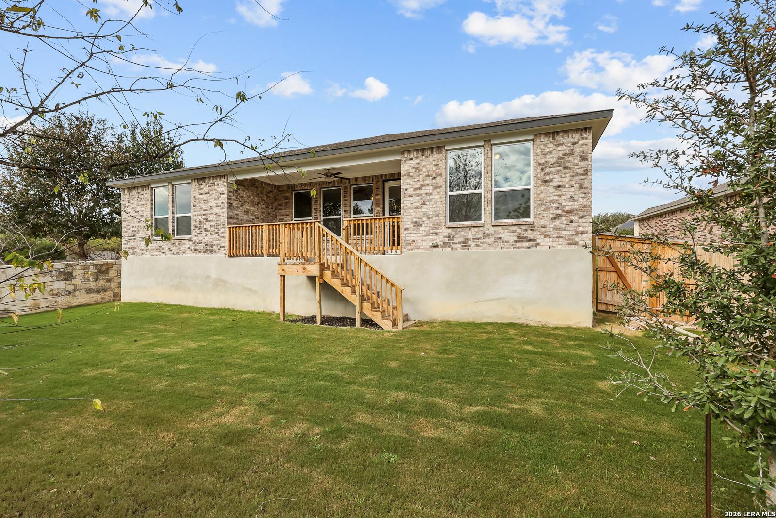 Brick exterior of The Lanier H floor plan by Davidson Homes with elevated wood deck overlooking backyard in Ladera, SA.