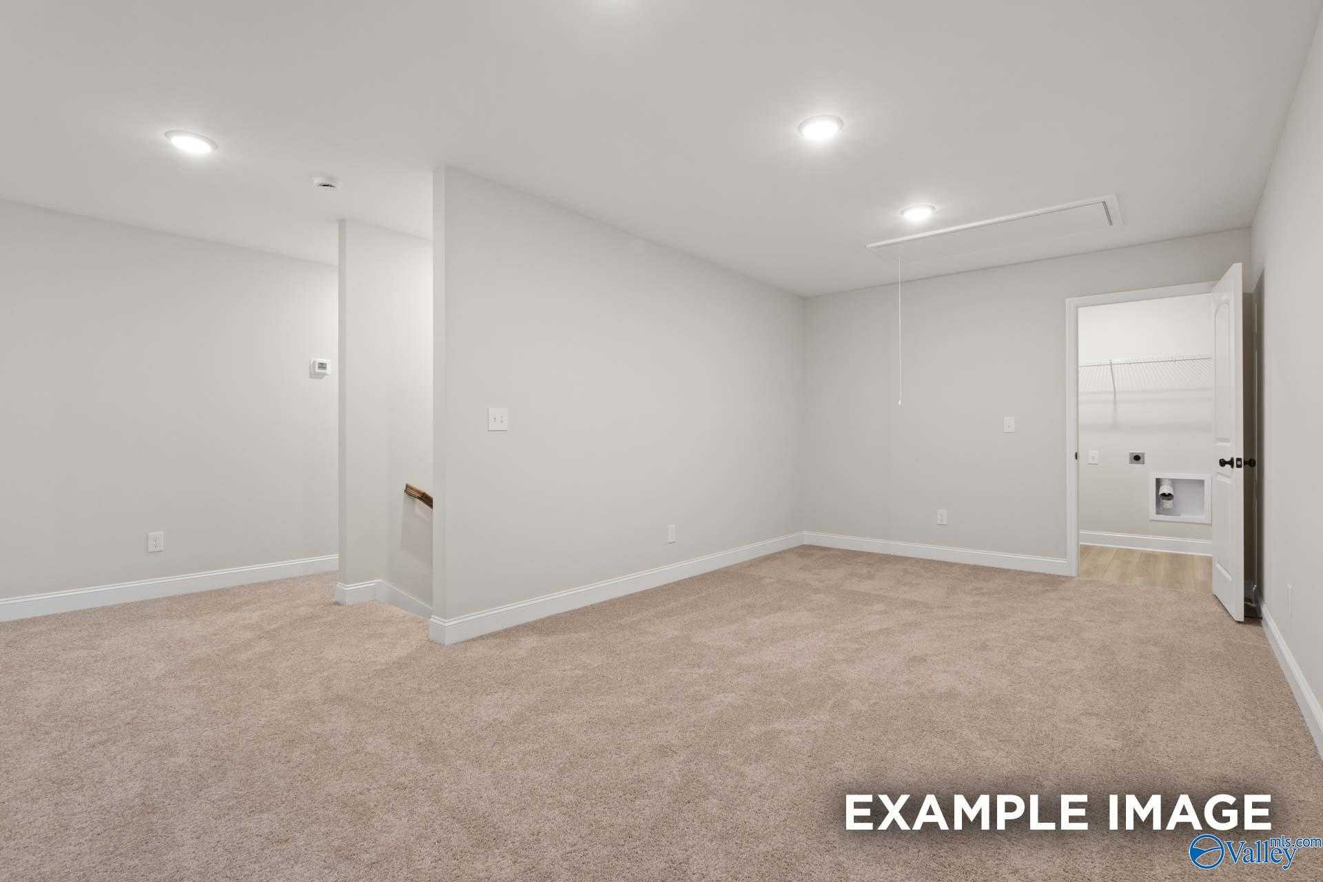 Empty upstairs bonus room featuring beige carpet, white walls, and recessed lighting in Davidson Homes The Camden D, Huntsville, Alabama