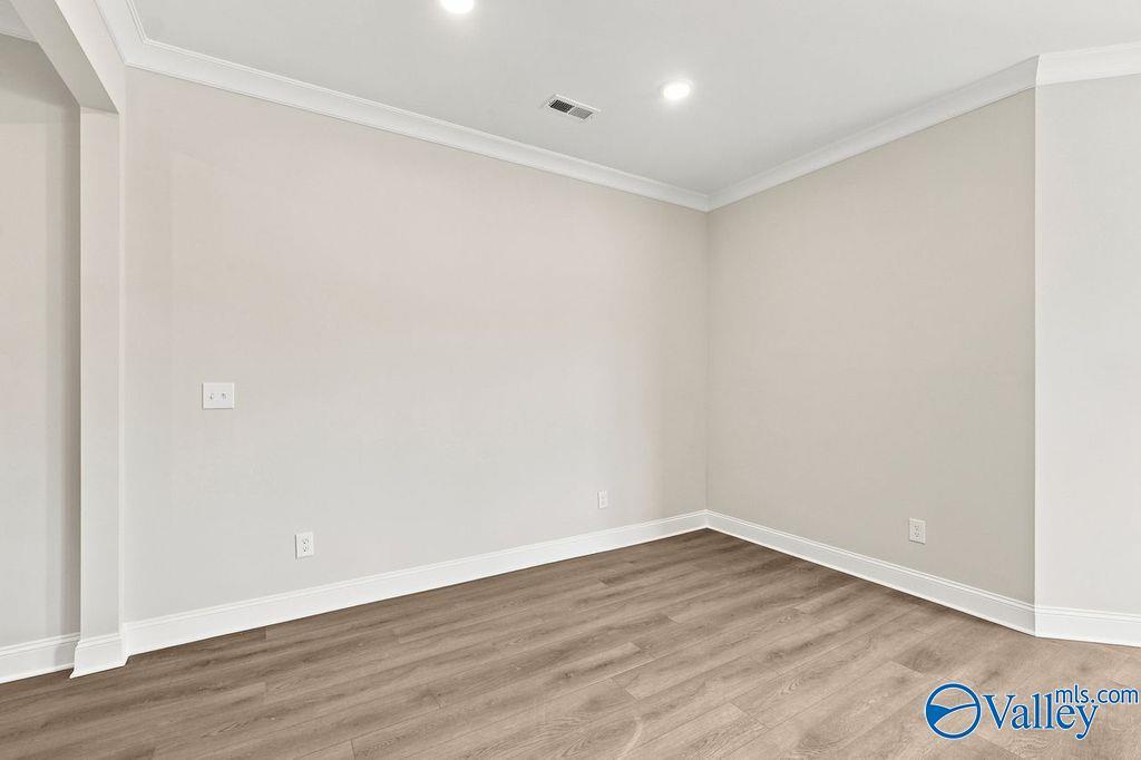 Bright, neutral-toned room with luxury vinyl plank flooring in The Camilla B floor plan at The Retreat at Cain Park.