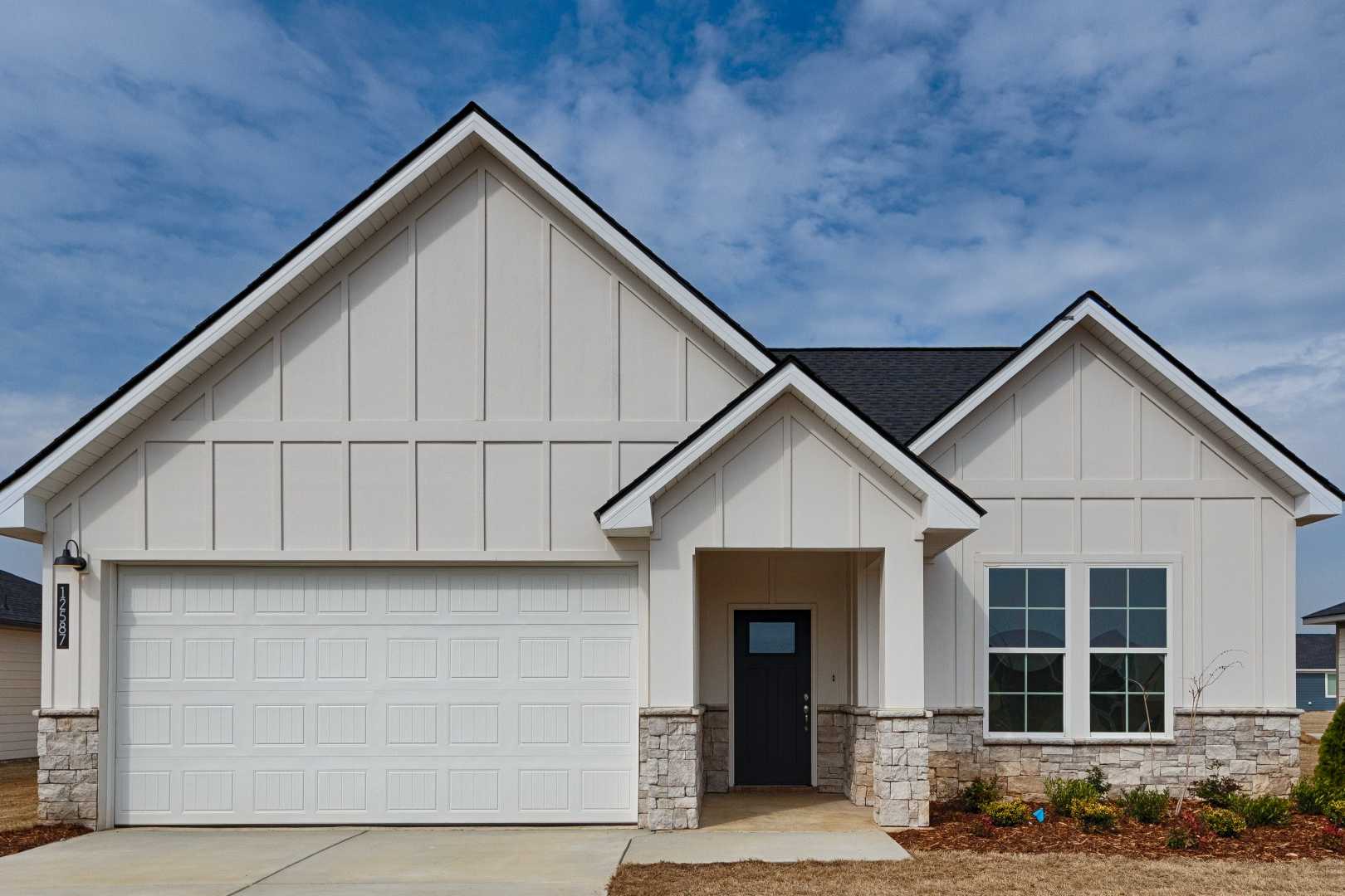 Modern farmhouse style home exterior at Links Crossing in Auburn Alabama with covered porch and attached garage