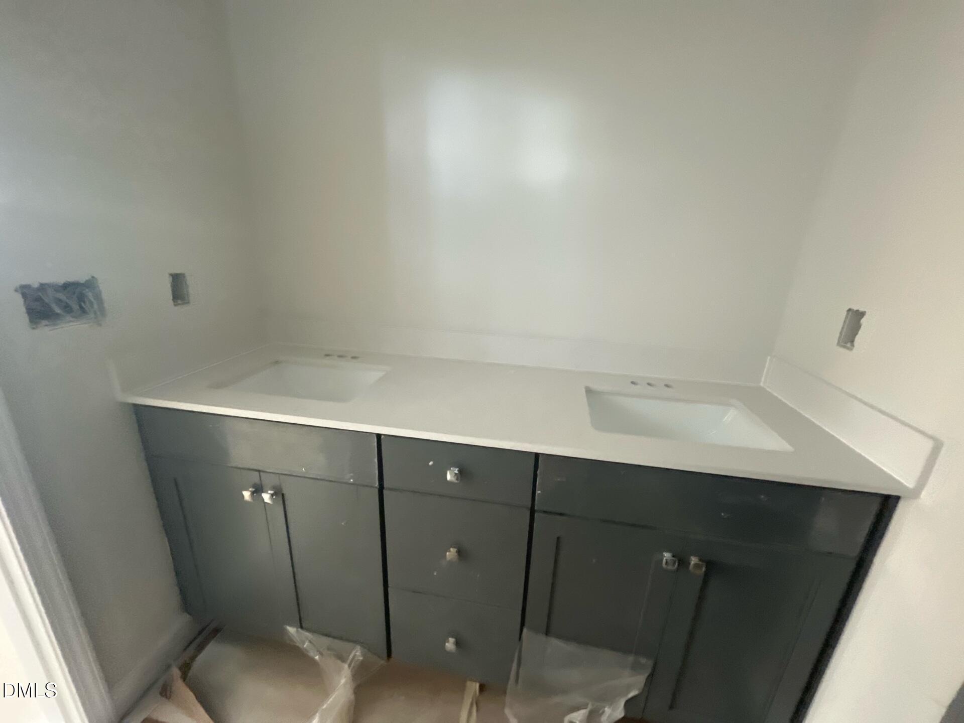 Modern double sink vanity with gray cabinets and white quartz countertop in primary bathroom, The Ashport G by Davidson Homes, Wake Forest, NC