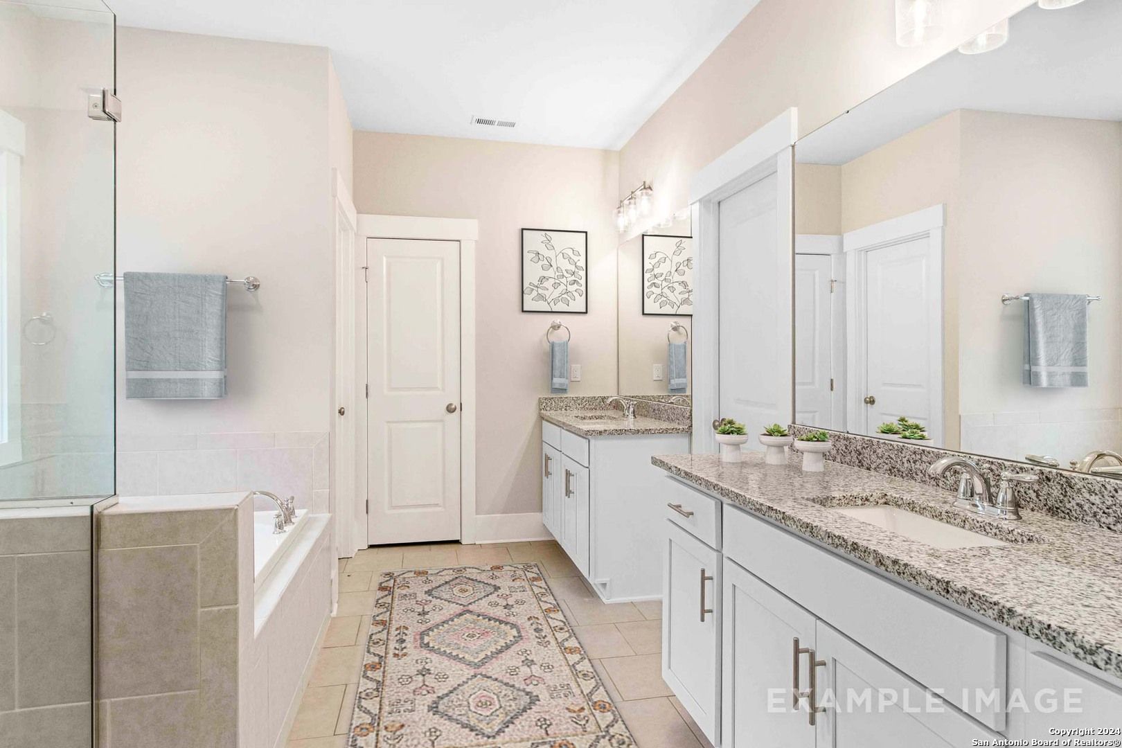 Elegant master bathroom with freestanding tub, glass shower, double granite vanity in The Lanier H by Davidson Homes, Ladera, San Antonio